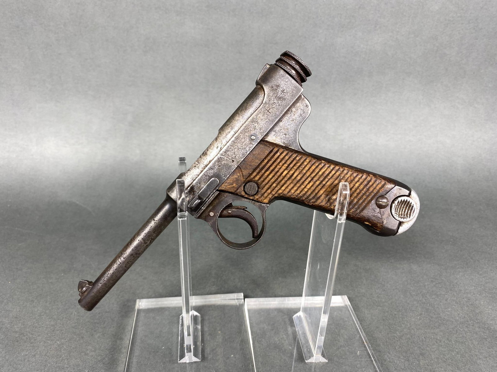 JAPANESE TYPE 14 NAMBU PISTOL FEB. 1929 W/MAG: BRAND: Nambu MODEL: Type 14 SERIAL: 02885 CALIBER/GAUGE: 8 mm CONDITION: Well used, but ok overall. Action is good. Bore is pitted with weak rifling. SIZE: 4.75" bbl. Notes: With magazine. Tokyo/Kokur