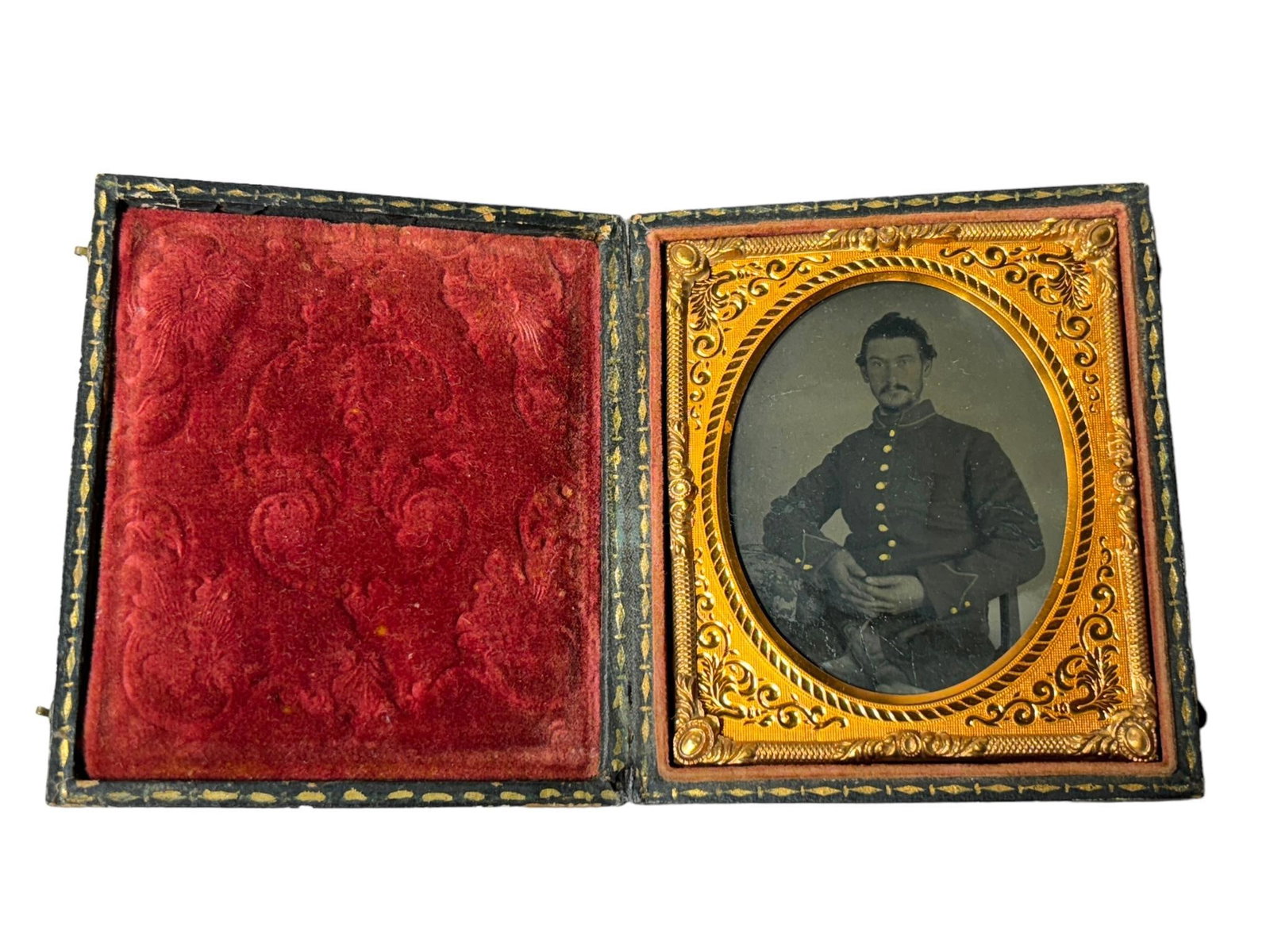 CIVIL WAR TINTYPE OF UNION SOLDIER: Civil War sixth plate tintype of a seated Union soldier. Small dimple on the image to the right of the frock coat buttons. Image is housed in a full leatherette case. In-house shipping is available. P