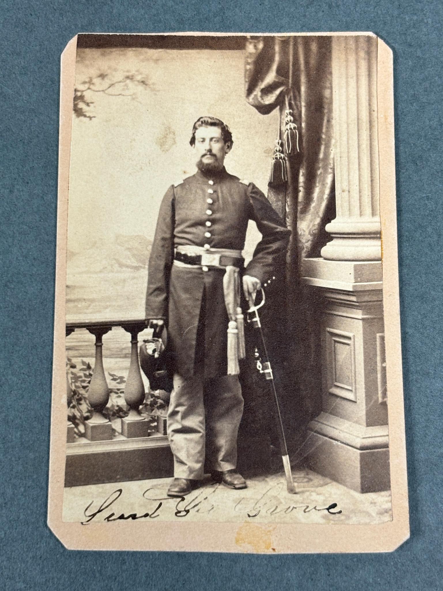 CIVIL WAR CDV IDED 1ST OHIO VOL INFANTRY - KIA: CDV of Lieutenant George J. Grove signed in ink below image as Lieut. Geo J. Grove. Full standing view of the officer wearing sash, officer’s frock and shoulder straps and sword, and holding cap wit
