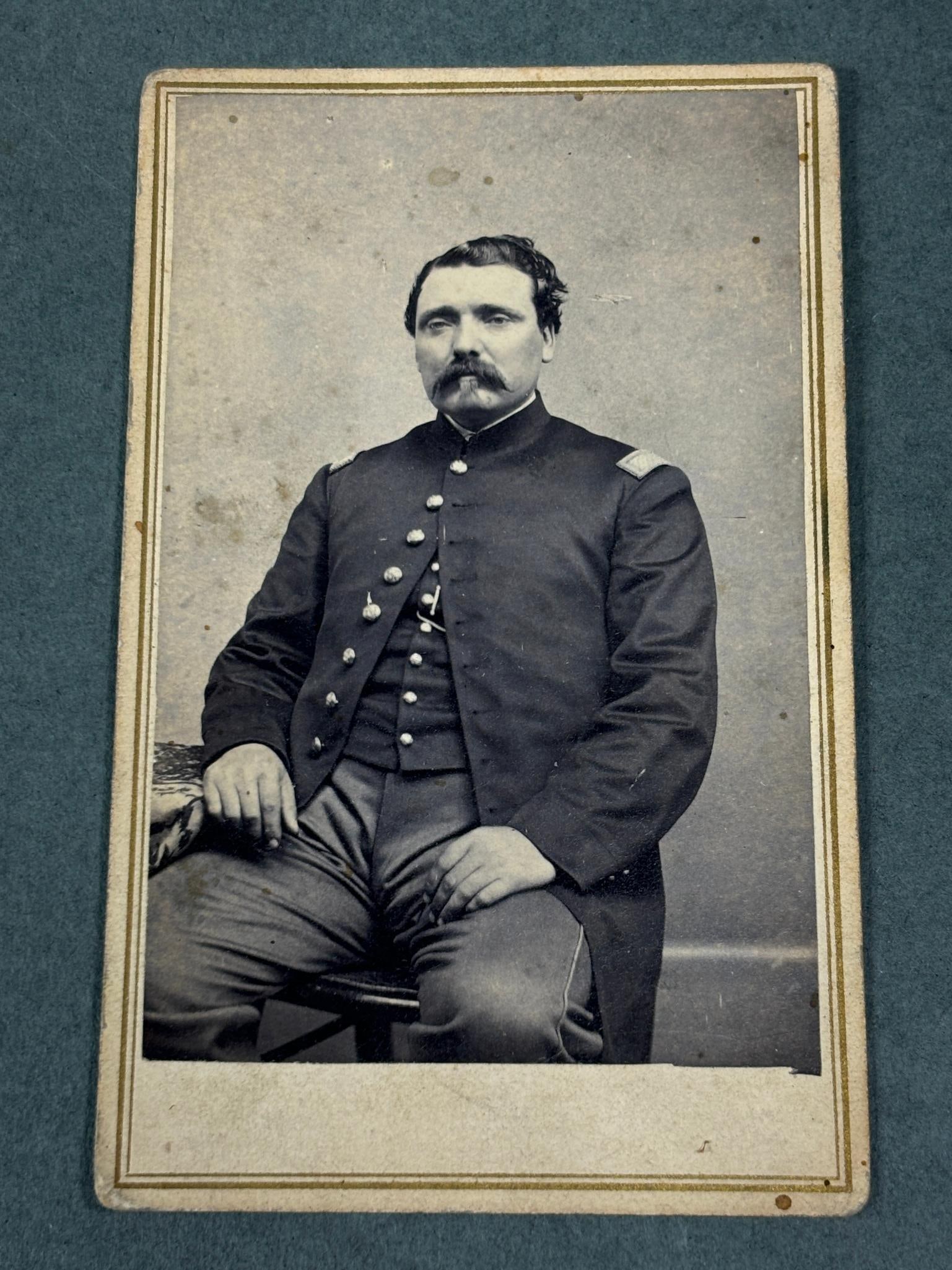 CIVIL WAR CDV NEWBURGH NEW YORK: CDV of unidentified officer seated wearing single-breasted frock with shoulder straps and vest. The backmark is for the photography studio Remillard in Newburgh, New York, which is located along the H