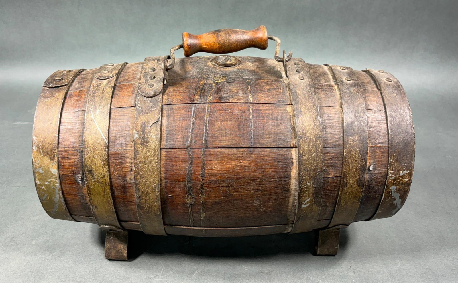 CIVIL WAR ERA AMBULANCE WATER KEG: Civil War era ambulance water keg. Measures 17.5" long and 8" in diameter at the ends. Oak staves and iron hoops, brass plug and spigot. The brass plug unscrews easily but the spigot is frozen. Wire h
