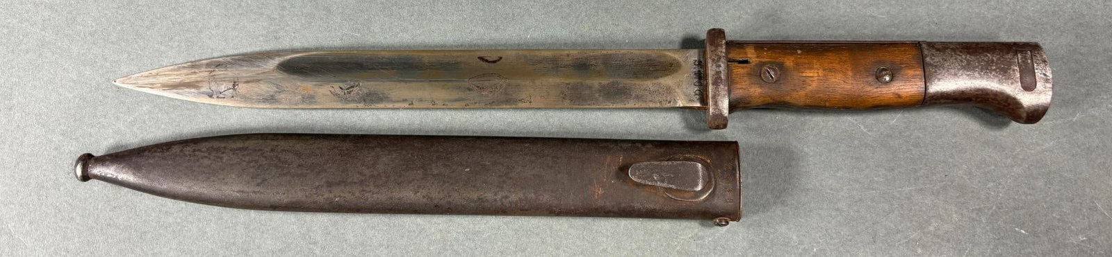 WWII NAZI GERMAN S84/98 BAYONET 1935 DATE: World War Two Nazi German S84/98 bayonet serial number 4605 with S.178.G code. "G" designates 1935 as year of production. Scabbard is mismatched - stamped "clc44" with serial number F2058. Stamped 195