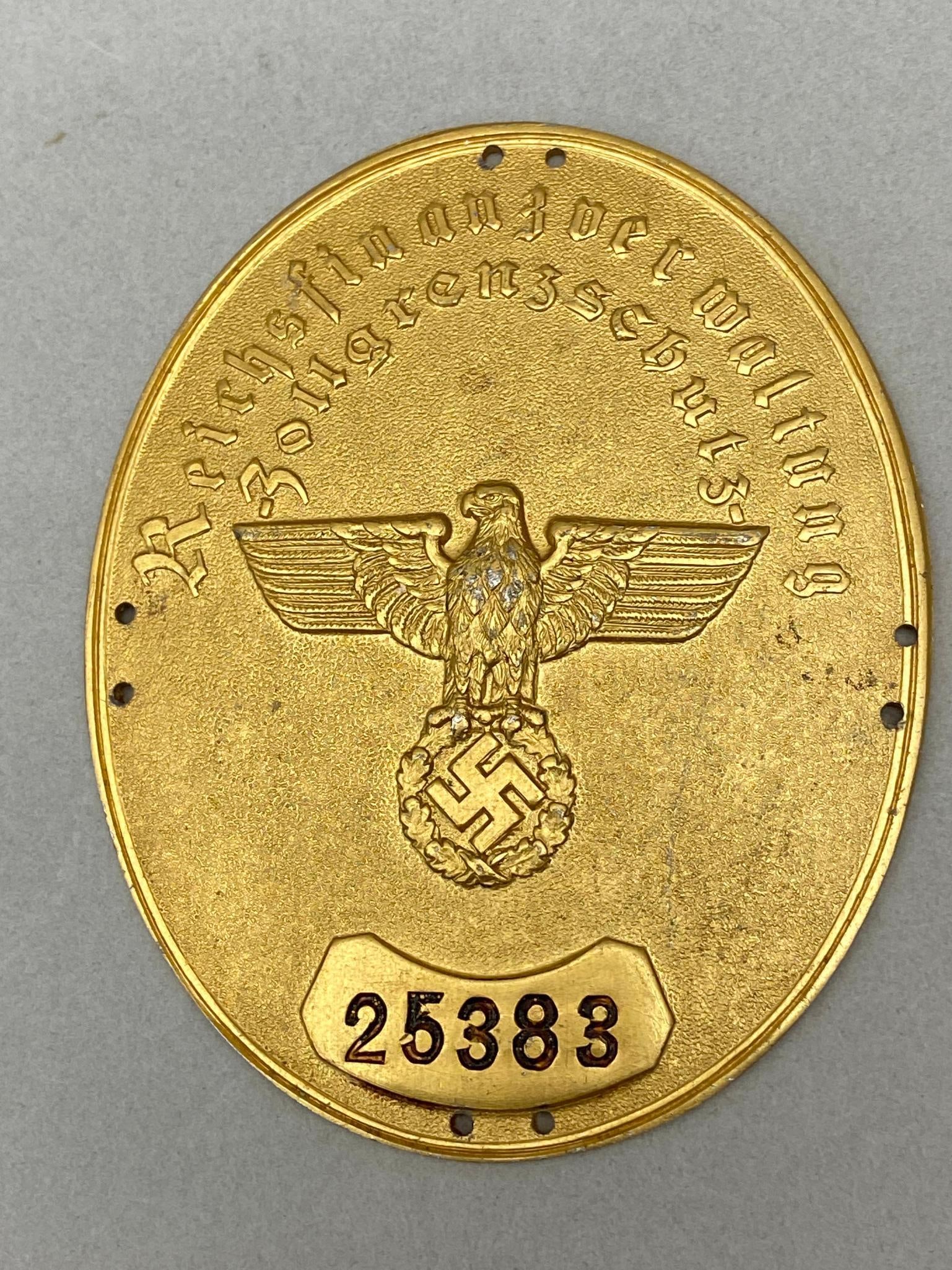 WWII NAZI GERMAN CUSTOMS BORDER SLEEVE ARM SHIELD: World War Two Nazi German Customs Border Protection Shield - Reichsfinanzverwaltung Zollgrenzschutz Armelschild. Stamped 25383. Measures 3.3125" x 2.6875" ( 82mm x 67mm). Excellent condition with a ti