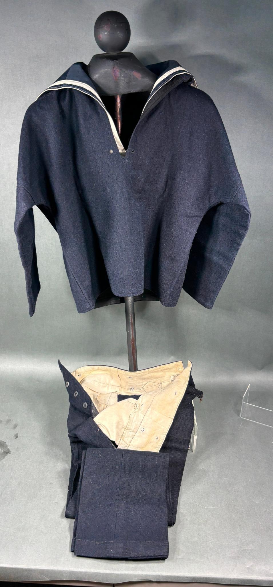 WWII IMPERIAL JAPANESE NAVY IDENTIFIED UNIFORM: World War Two IJN seaman's blue wool uniform identified on the jumper label to Mutsuo Baba registration number 81851. The jumper was issued from the Yokosuka Naval Arsenal and bears a production date