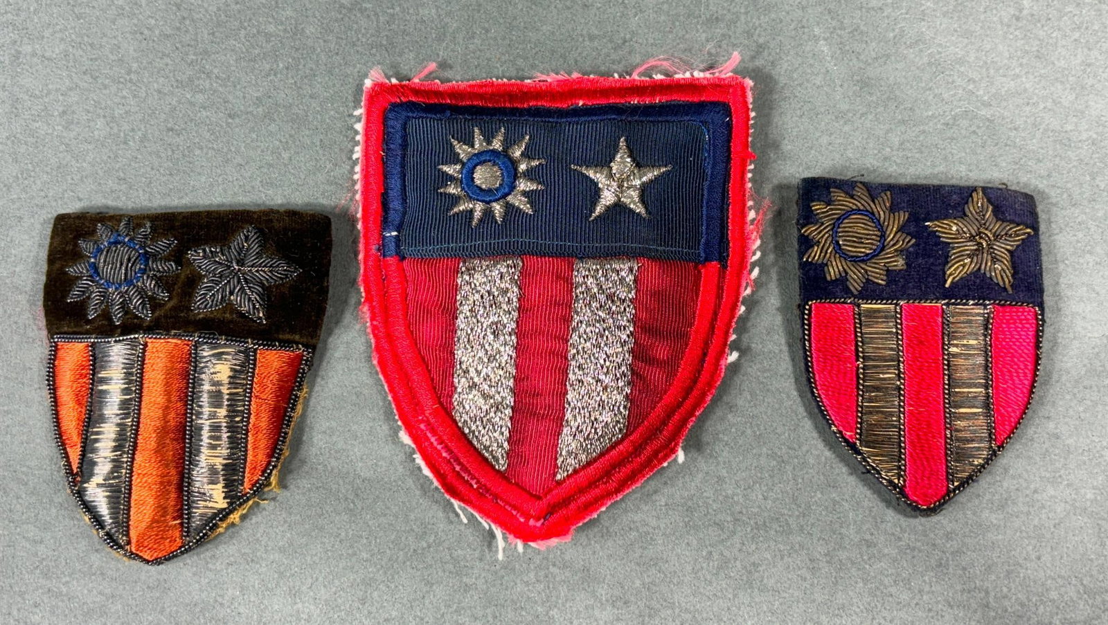 WWII U.S. THEATER MADE BULLION CBI PATCH LOT: World War Two lot of three theater made bullion CBI - China Burma India patches. The largest patch measures 4" x 3.25" and is bullion on a coarse ribbed corduroy type material, the other two are bulli