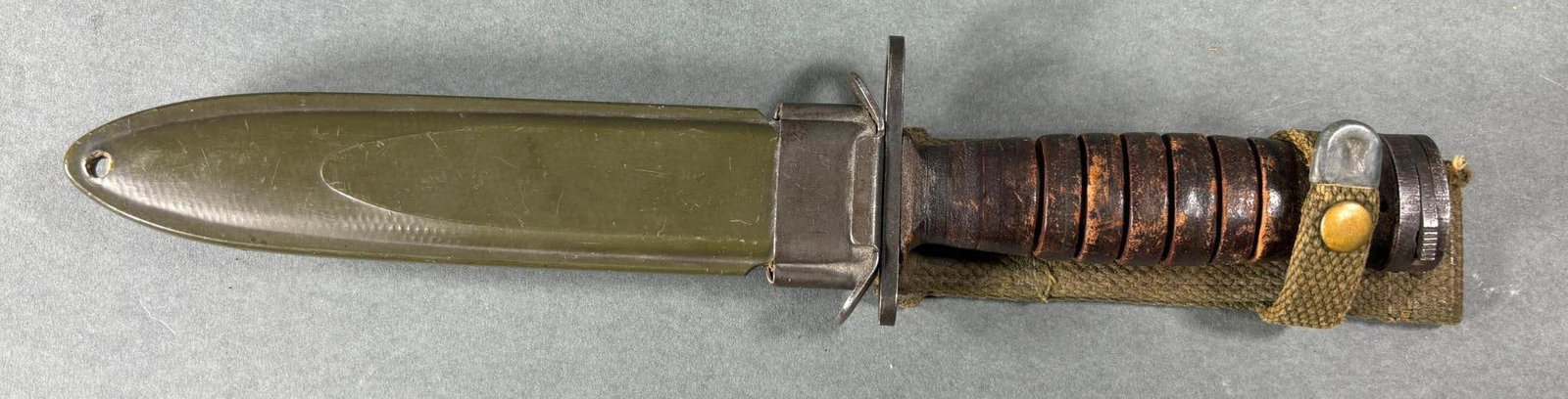 WWII USM4 M1 UTICA BAYONET WITH SCABBARD: World War Two era USM4 Utica bayonet and M8A1 B. M. Co. Leather grips in good condition with a few spots of wear. Blade has been slightly sharpened. In-house shipping is available. Pickup is Monday, A
