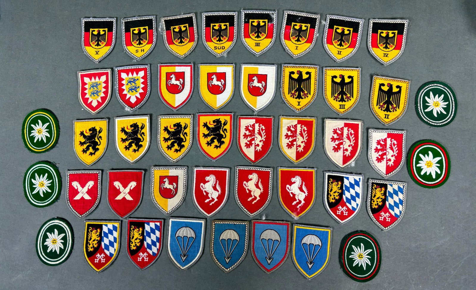 POST WWII GERMAN MILITARY PATCH LOT: Lot of 44 post WW2 West German military - army multi piece construction patches. A previous owner identified many of the patches with pieces of removable tape on the reverse. Patches measure approxima