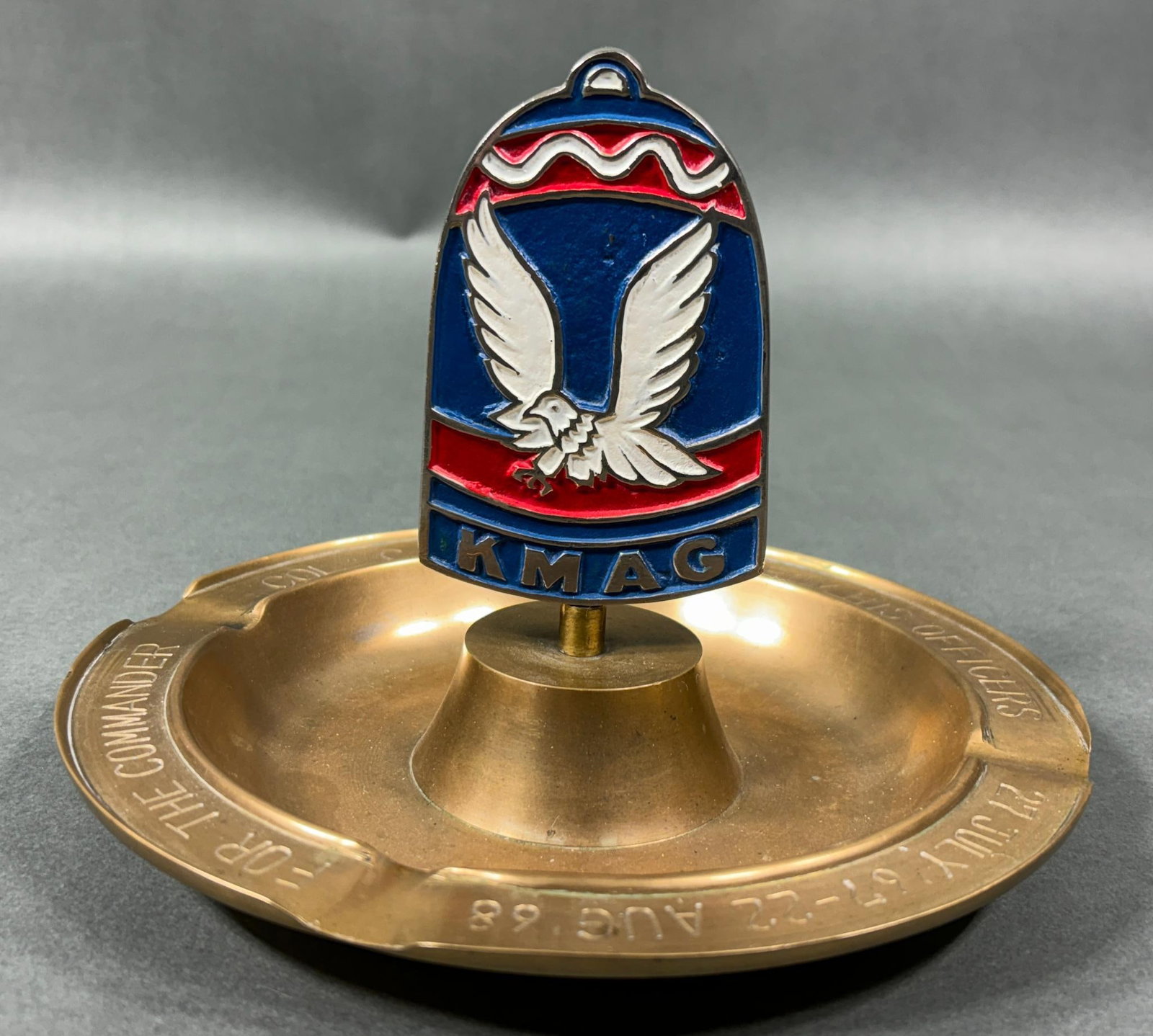 VIETNAM ERA 1968 KMAG PRESENTATION ASHTRAY: Vietnam era 1968 presentation ashtray. Presented "FOR THE COMMANDER COL. C. W. BAKER FROM HIS OFFICERS 27 JULY '67 - 22 AUG. '68". The ashtray features a 4" KMAG (Korean Military Advisory Group) insig