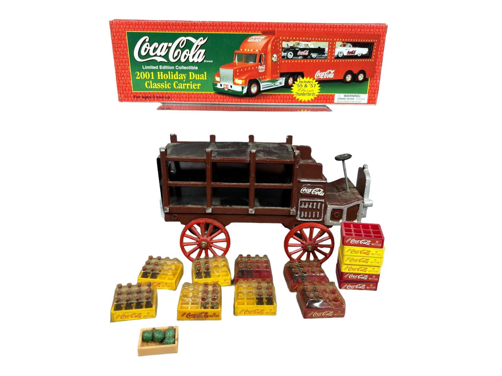 Cast Iron Coca-Cola Delivery Wagon With Cases of Bottles and 1991 Holiday Truck Carrier: In-house shipping is available. Pickup is Tuesday, June 4th from 1 pm to 7 pm and Wednesday, June 5 from 11 am to 3 pm at our offices in Carroll, OH 43112 or we will provide in-house shipping for this