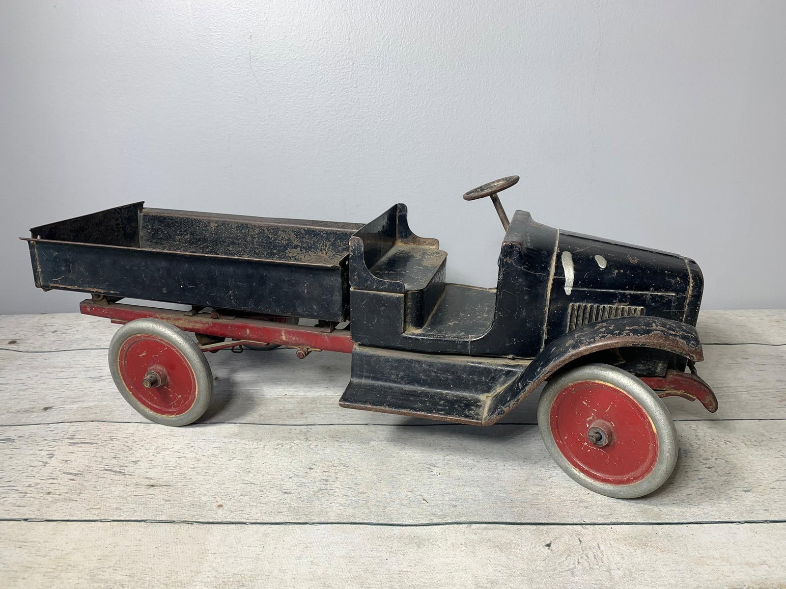 Early 1900's Buddy-L Large Size Dump Truck Pressed Steel: Steel wheels, crank dump bed with tailgate. 24 inches long. Nice old toy. In-house shipping is available. Pickup is Tuesday, June 4th from 1 pm to 7 pm and Wednesday, June 5 from 11 am to 3 pm at our