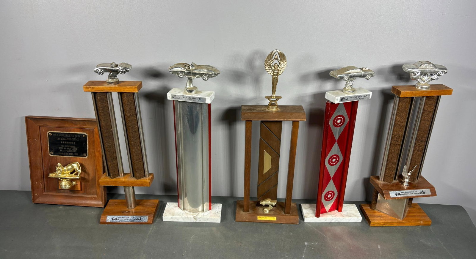 Group of Vintage Racing Trophies Plus Company Award Plaque for Liquor Distribution: In-house shipping is available. Pickup is Tuesday, June 4th from 1 pm to 7 pm and Wednesday, June 5 from 11 am to 3 pm at our offices in Carroll, OH 43112 or we will provide in-house shipping for this