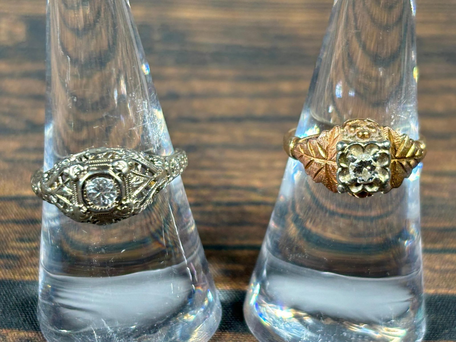 Two Antique Gold Rings 10k & Diamond, 18k & Gemstone: Gold ring with leaves is 10k gold with small center diamond that is I1 clarity, size 7 1/2. It weighs 3.25 grams. The white gold ring is 18k gold, size 9, 3.98 grams with a .10 carat center spinel gem