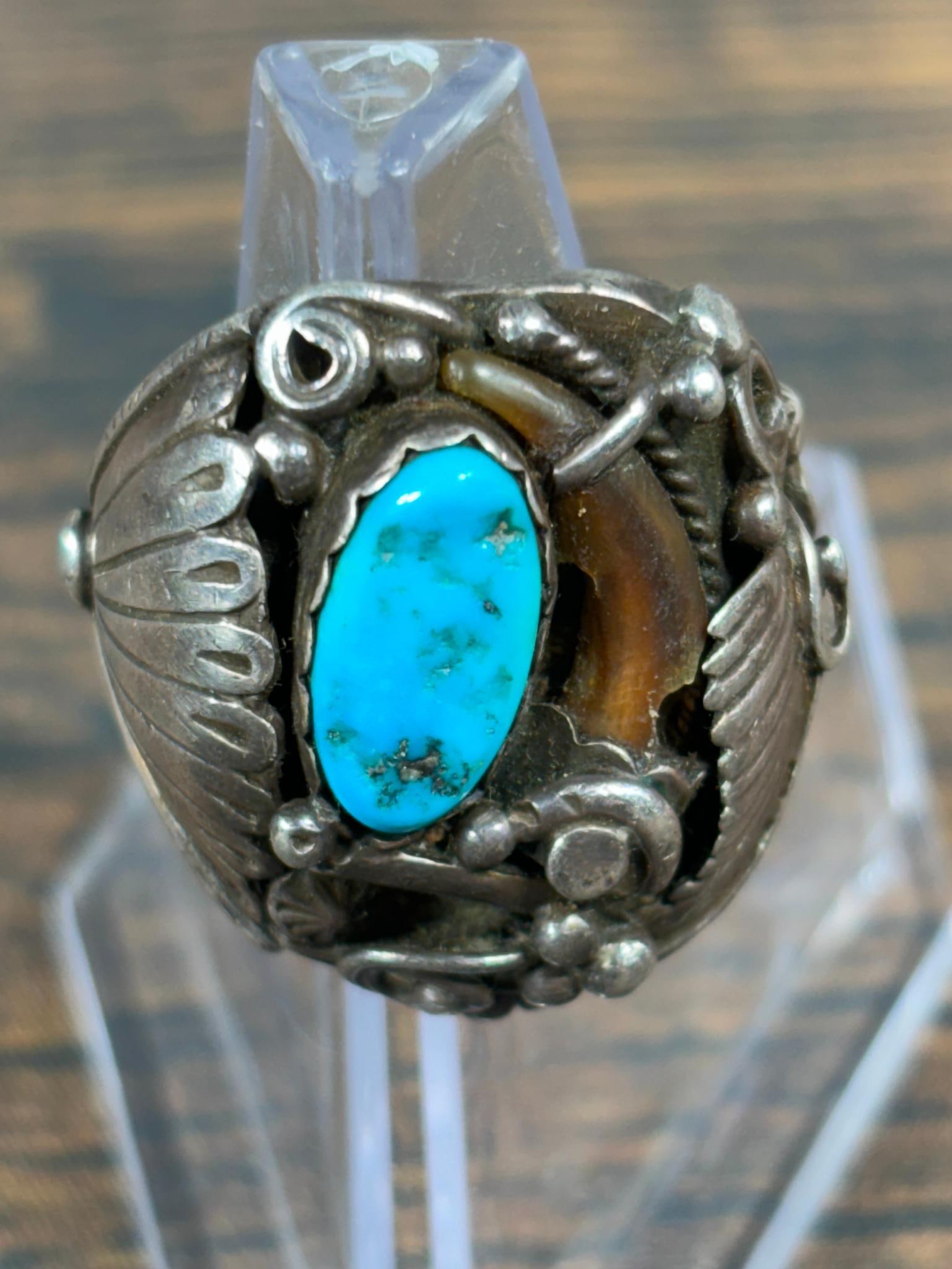 Vintage Native American Sterling Silver, Bear Claw, Turquoise Ring: Size 12, weight 27.52 grams. Signed illegibly. Bear claw has a chunk missing. In-house shipping is available. Pickup is Friday, August 9th from 11 am to 7 pm at our offices in Carroll, OH 43112 or we 