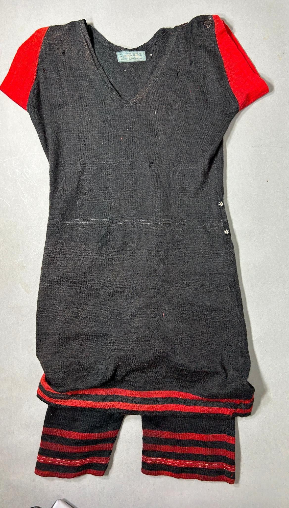 Antique Woman's Bathing Suit by Lipman Wolfe & Co. Paris & Portland Oregon: Original 1910s - 1920s vintage woman's V-neck bathing suit. The collar tag reads, "Lipman Wolfe & Co Paris, Portland, Ore.". The suit is black with red trim and is made of soft wool. The waist is 29.5