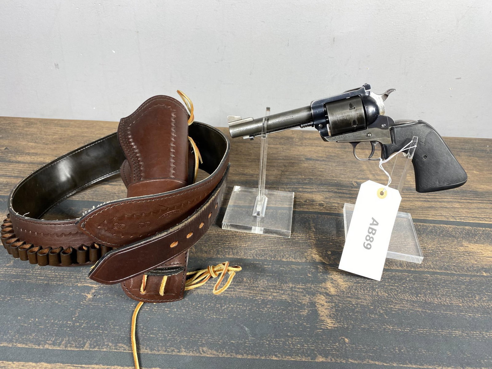 * Ruger New Model Super Blackhawk 44 Magnum Revolver: BRAND: Ruger MODEL: New Model Super Blackhawk SERIAL: 82-4884 CALIBER/GAUGE: 44 Magnum CONDITION: Action good, bore good. SIZE: 5" bbl NOTES: With holster, belt and a few rounds. In house shipping ava