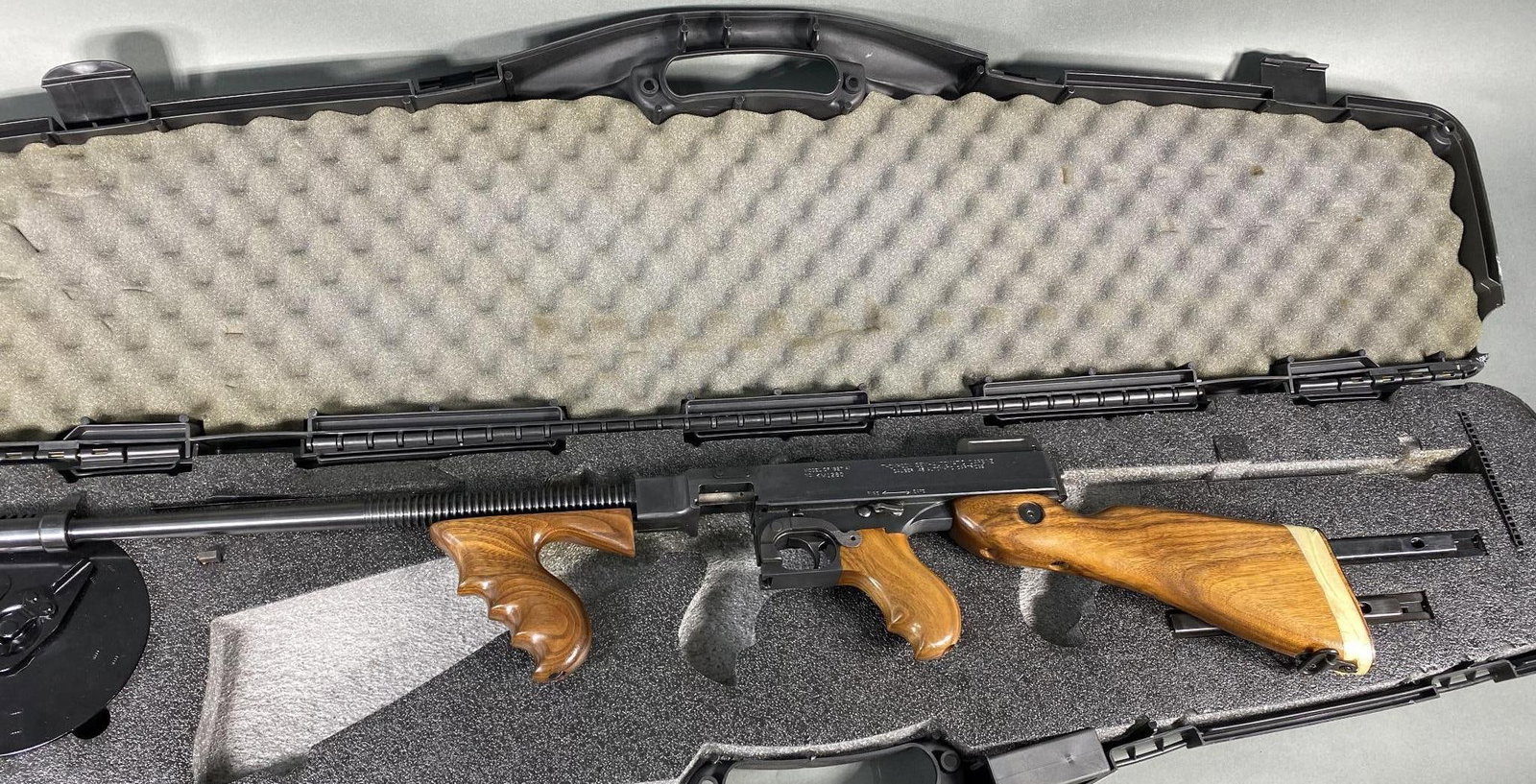 # Auto Ordnance Thompson 1927 A-1 Rifle w/Drum, 2 stick mags in case Deluxe: MFG/IMPORTER: Auto Ordnance Corp. MODEL: 1927 A-1 SERIAL: KM1280 CALIBER/GAUGE: 45 ACP CONDITION: Action good, bore good. Very nice except someone shortened the stock by a couple of inches. It could b