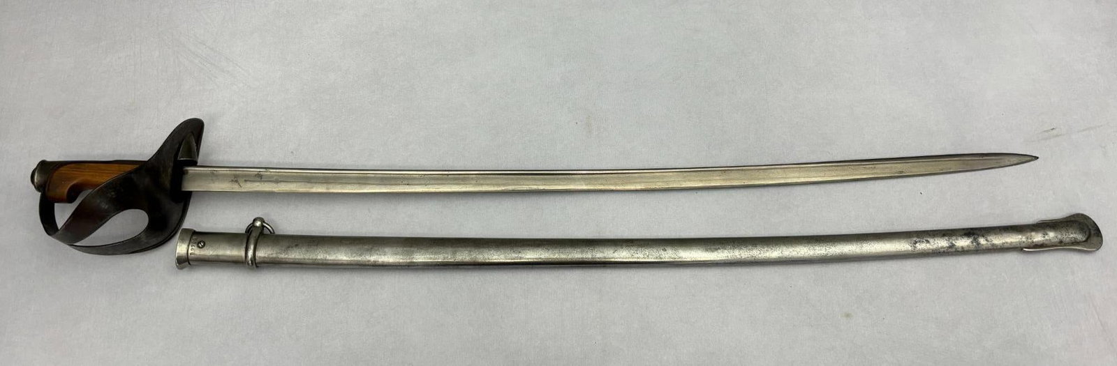 Italian M1871 Cavalry Saber: Model 1871 Italian cavalry saber with a slightly curved blade. Overall length is 41.75" with a 35.75" blade. Stamped RC in an oval on the ricasso. The blade appears to have been cleaned and lightly sh