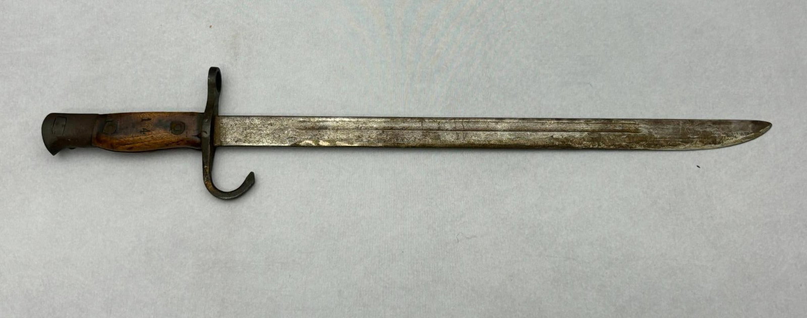 WWII Type 30 Japanese Bayonet with "14" Stamped On Grips No Arsenal Stamps on Blade: World War Two Type 30 bayonet with no arsenal stampings on the blade. The wooden grips are stamped "14". Hooked quillon, bird's head pommel and contoured grips with rivets. Press stud release device i