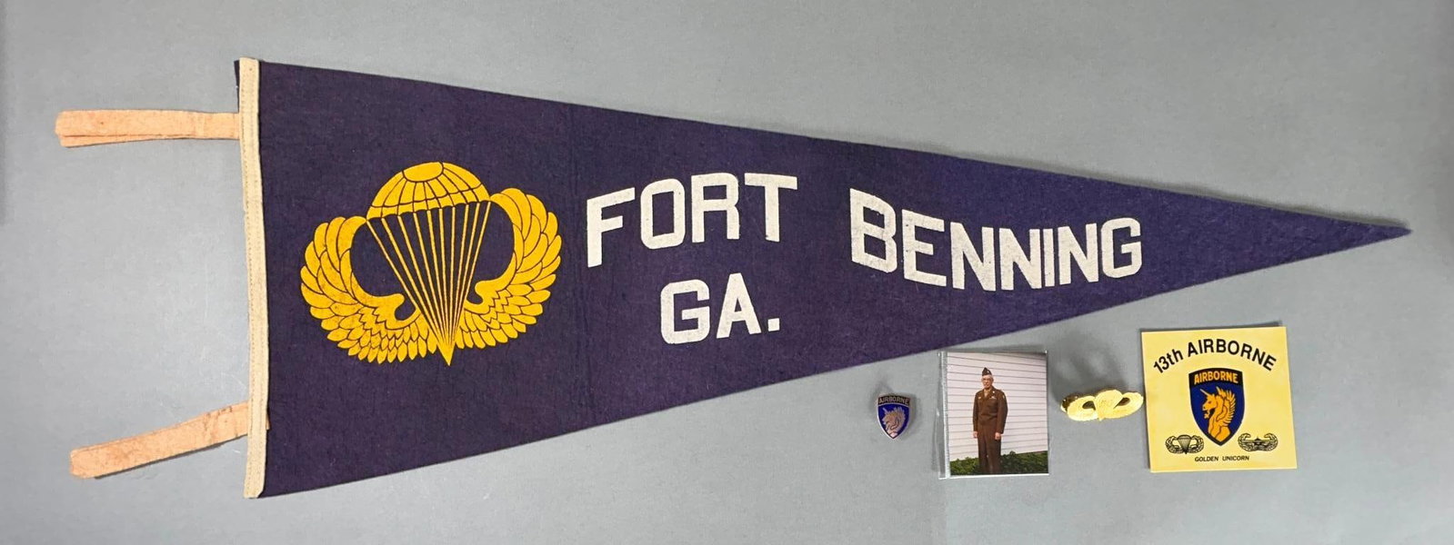 WWII Circa 1944 Fort Benning Airborne Paratrooper Pennant: World War Two Fort Benning pennant purchased by paratrooper Dell Beekman after he finished jump school at Fort Benning in 1944. Pennant measures 29" x 11". Excellent condition and still retains vibran