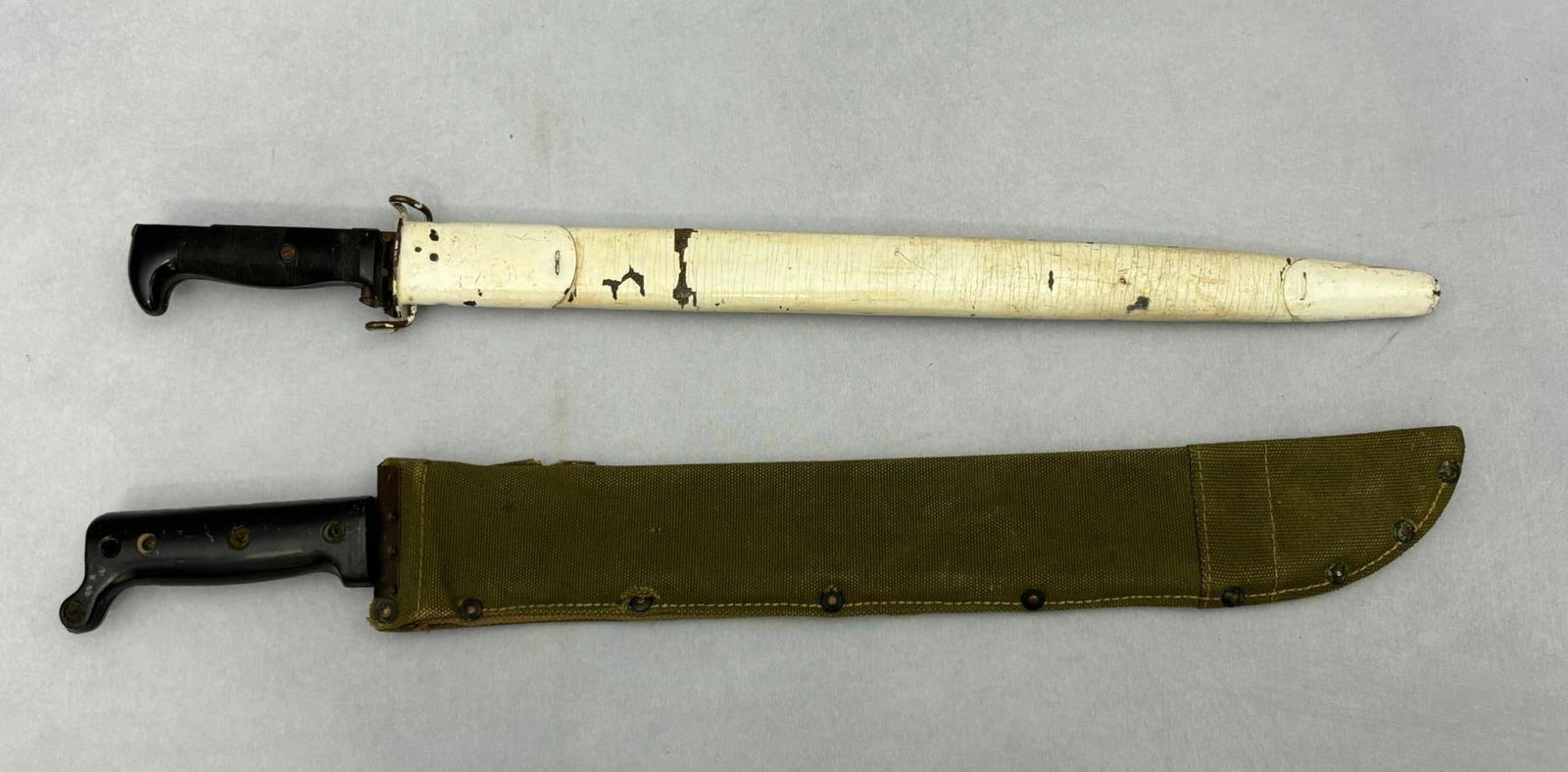 WWII USN Mk1 Training Bayonet & U.S. Army Jungle Machete: World War Two lot consisting of; 1. United States Navy Mark 1 training bayonet for use with the U.S. Navy Mark 1 Dummy Training Rifle. The blade and grips are made of a hard bakelite plastic. The rica