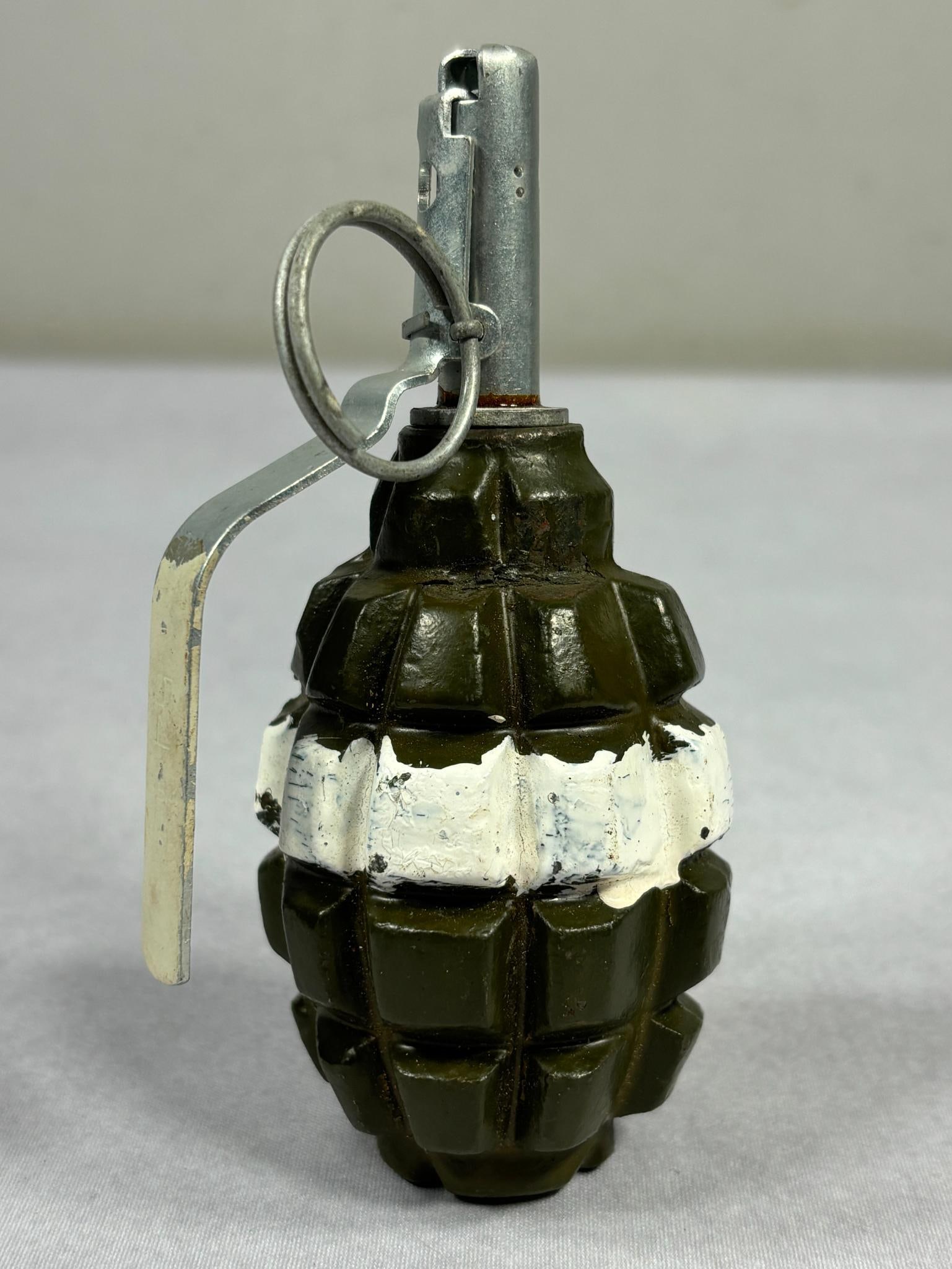 Polish Cold War F-1 Training Hand Grenade (inert): Cold War era Polish F-1 training hand grenade - fragmentation type. Made in the style of a WWII pineapple hand grenade. The white paint stripe on the body and handle designates training. Overall lengt