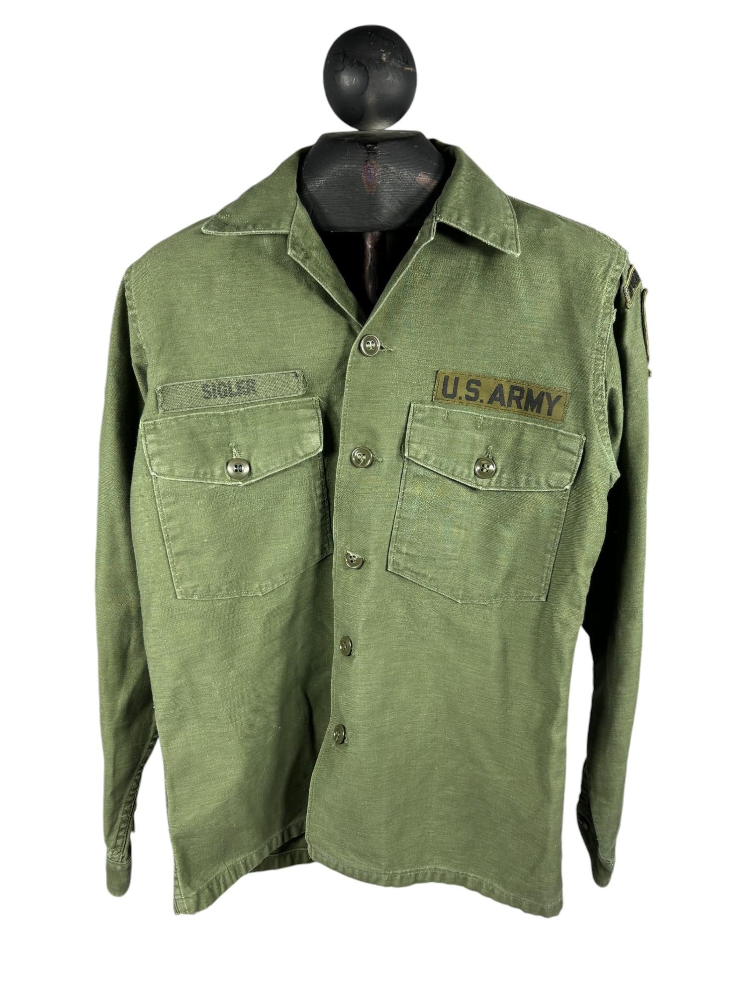 Vietnam War United States Special Forces Shirt with 1965 DSA Code: Vietnam War U.S. Army sateen shirt with a subdued arrowhead Airborne 5th Special Forces Patch. Contract tag near bottom hem is DSA-1-8349 (1965 contract date). Size tag 14 1/2 x 33. Name tag reads "Si