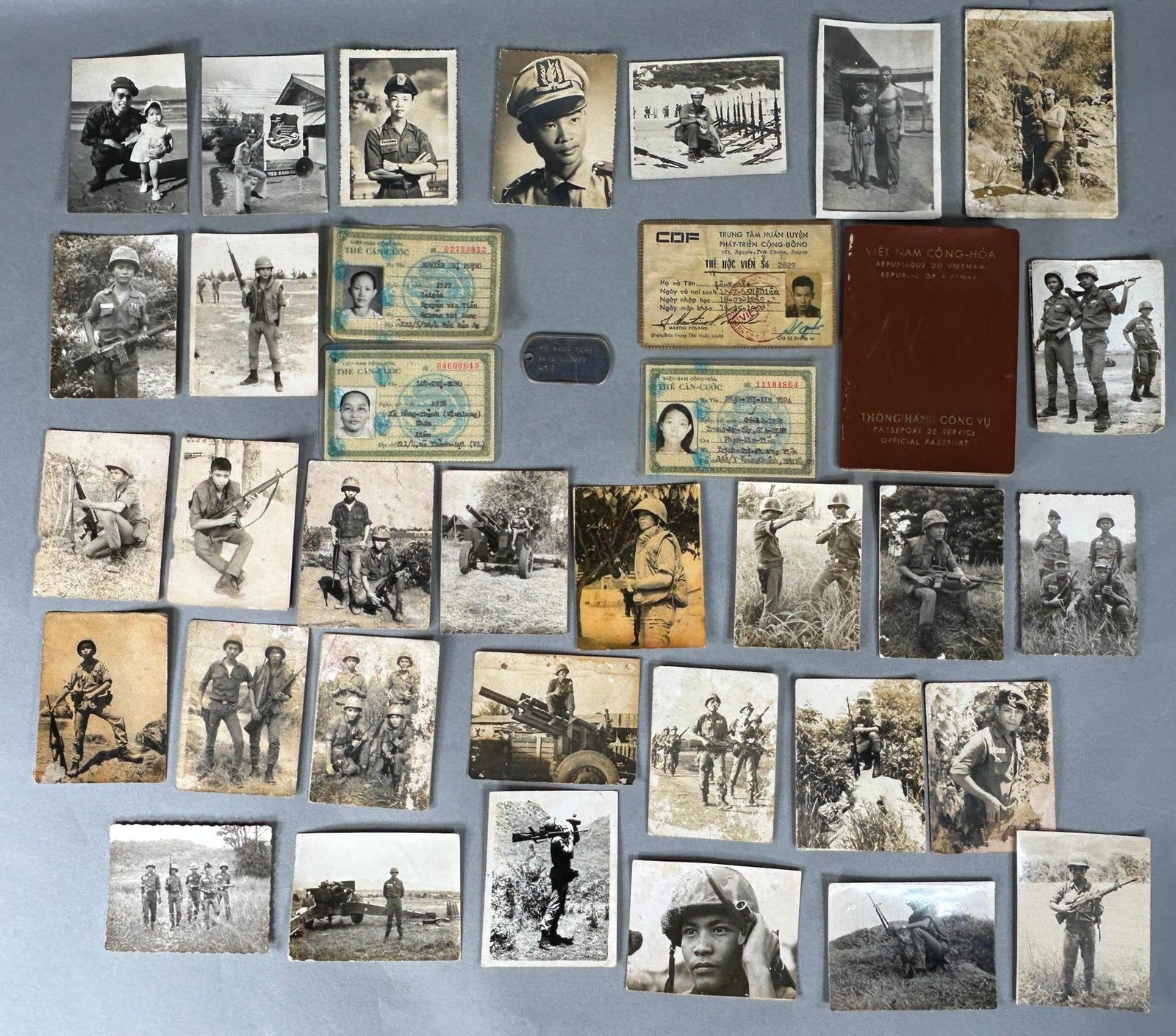 Vietnam War South Vietnamese Lot - ARVN Dog Tag Photographs, and Identification cards: Vietnam War South Vietnam soldier and civilian lot including a dog tag, two female civilian identification cards, 1969 Community Development Training Center ID card, a Vietnamese passport with many st