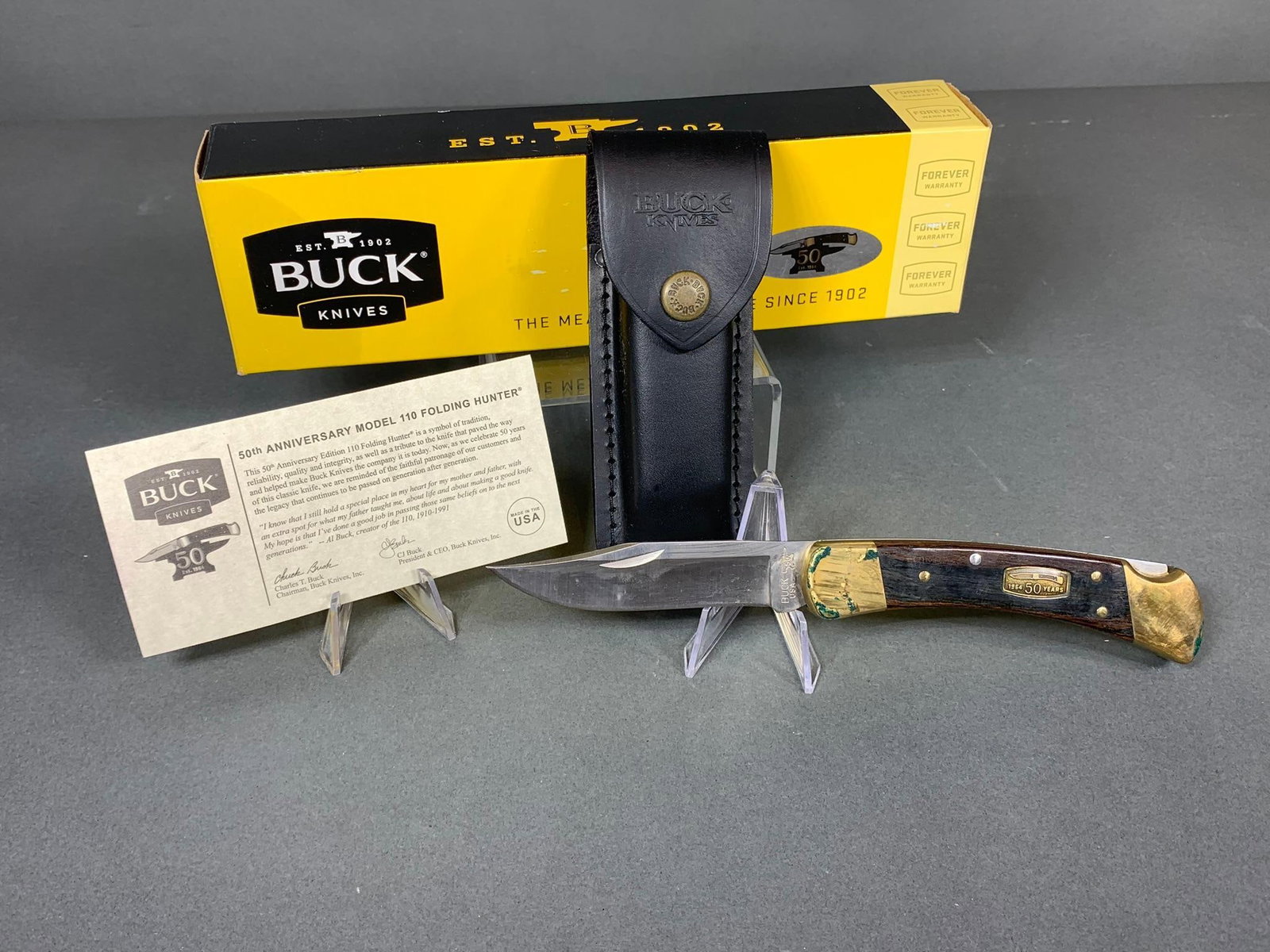 Vintage Buck 50th Anniversary Model 110 Folding Knife with Leather Sheath and Box: In-house shipping available. Pickup is Monday, Feb 17 from 11 am to 7 pm and Tuesday Feb 18 from Noon to 4 pm at our offices in Lancaster, OH 43130 (we moved! Just down the road) or we will provide in