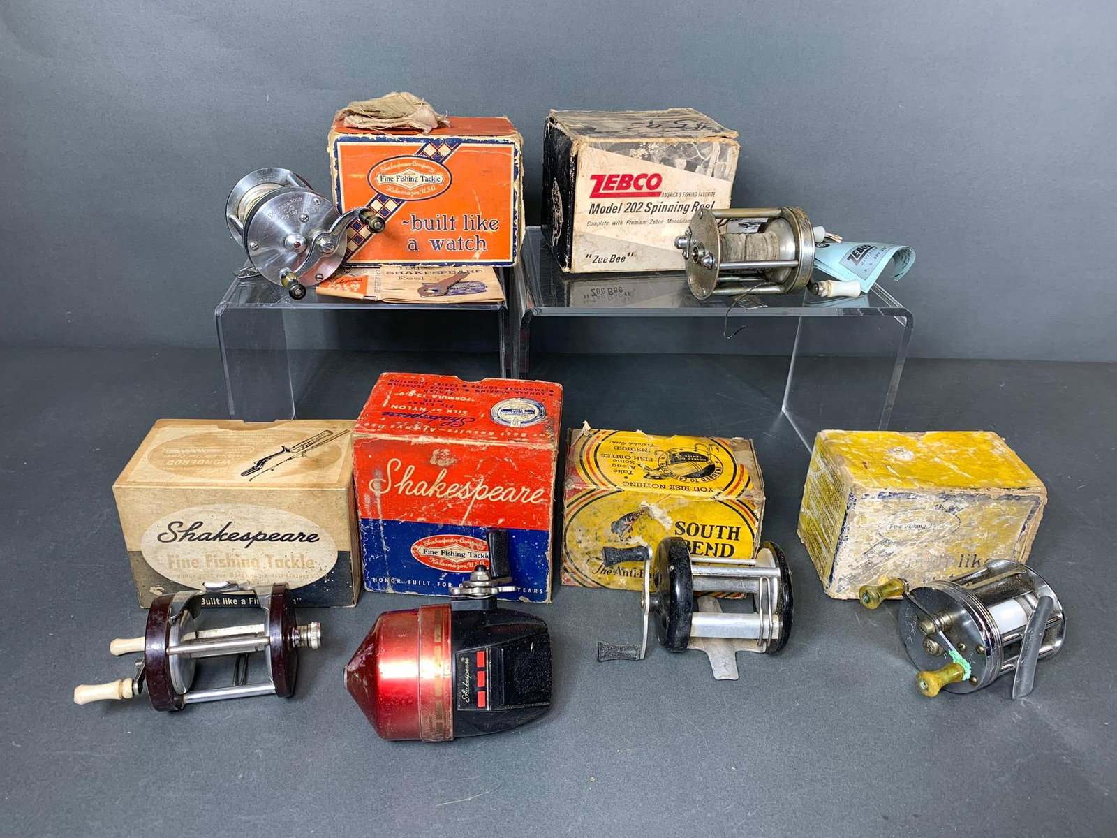 Group of Six Vintage Fishing Reels with Original Boxes: Shakespeare, Zebco, South Bend: In-house shipping available. Pickup is Wednesday, April 30 from 1 pm to 7 pm at our offices in Lancaster, OH 43130 or we will provide in-house shipping for this item. We charge a $5/lot fee if you pic