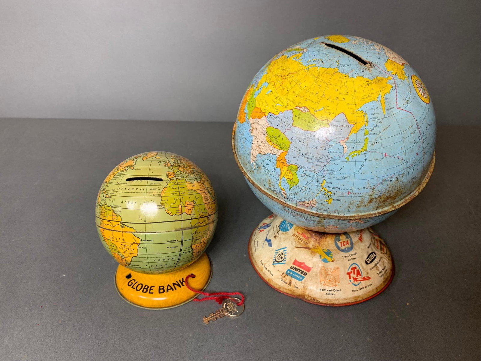 Vintage Chein World Globe Bank and Larger Ohio Art Globe Bank: Chein bank has key, Ohio Art Bank no key. In-house shipping available. Pickup is Wednesday, April 30 from 1 pm to 7 pm at our offices in Lancaster, OH 43130 or we will provide in-house shipping for th