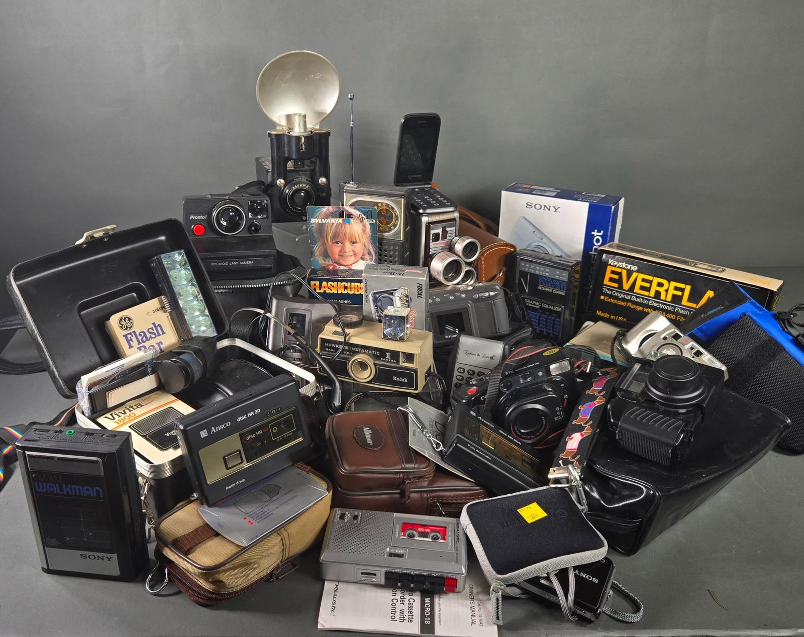 Group Lot of Vintage Cameras, Movie Cameras, Tape Recorders, and Other Electronics: In-house shipping available. Pickup is Thursday, May 29 from from 1 pm to 7 pm at our gallery in Lancaster, OH 43130 or we will provide in-house shipping for this item. We charge a $5/lot fee if you p