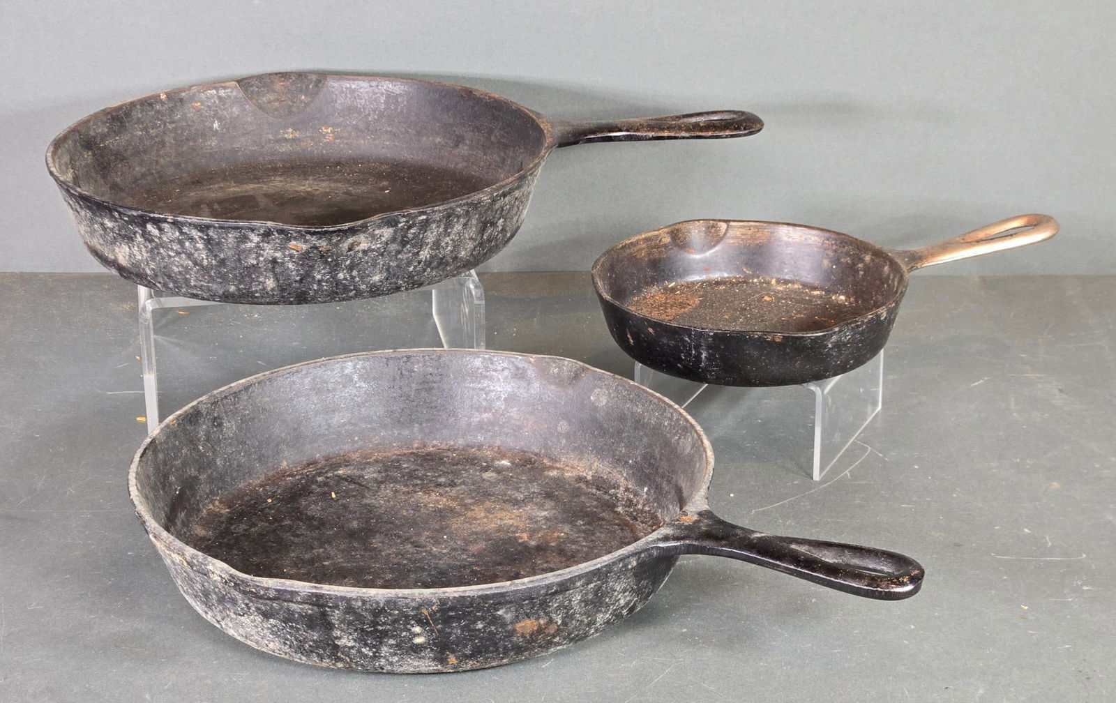 Three Vintage Cast Iron Skillets Including Griswold: In-house shipping available. Pickup is Thursday, May 29 from from 1 pm to 7 pm at our gallery in Lancaster, OH 43130 or we will provide in-house shipping for this item. We charge a $5/lot fee if you p