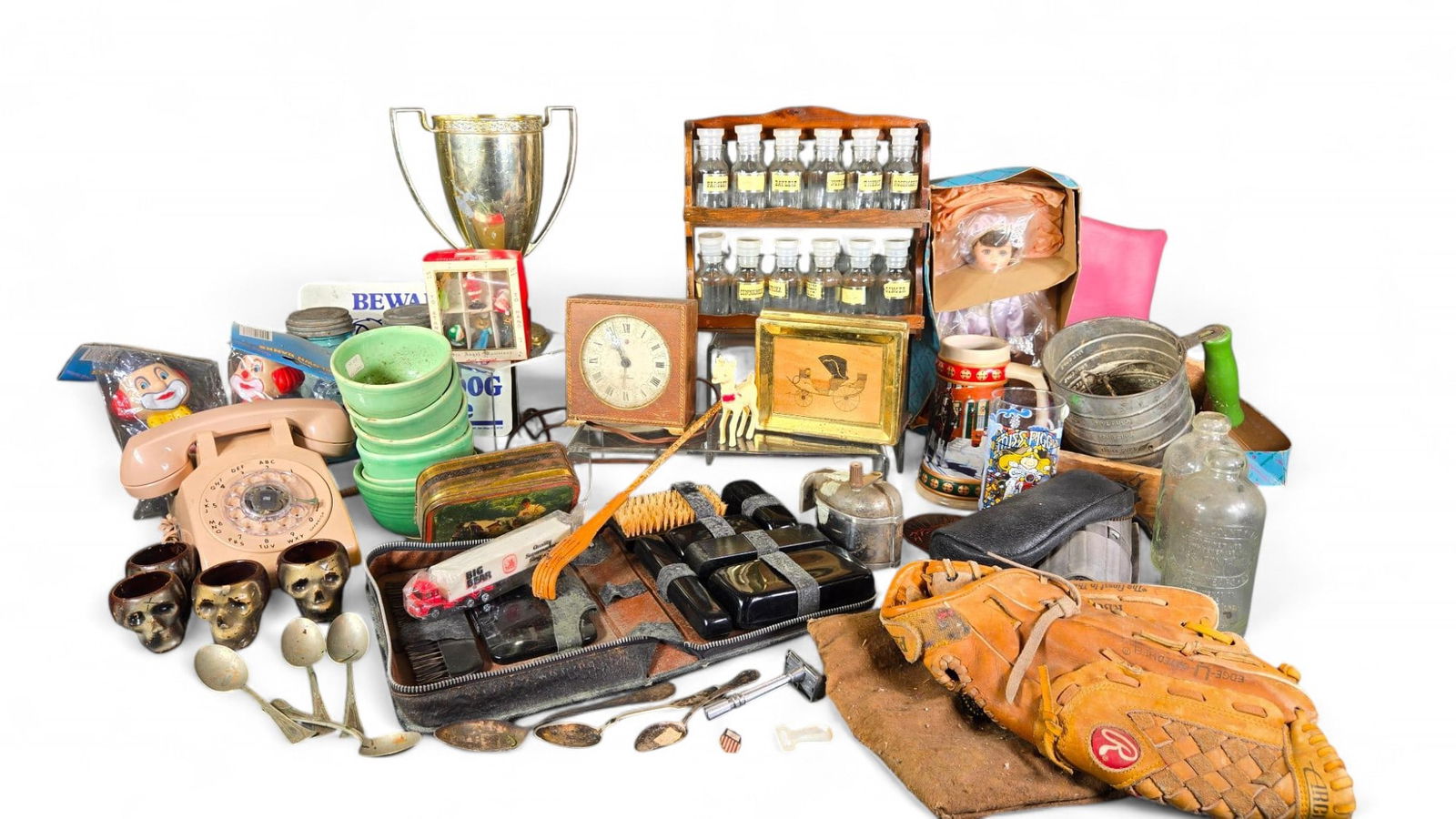 Group of Vintage Items: Baseball Glove, Clock, Rotary Phone, Silver Plate, Redware Skulls, More: Aqua Jars, Collectible Glasses, Spice Rack with Bottles. More. AB189