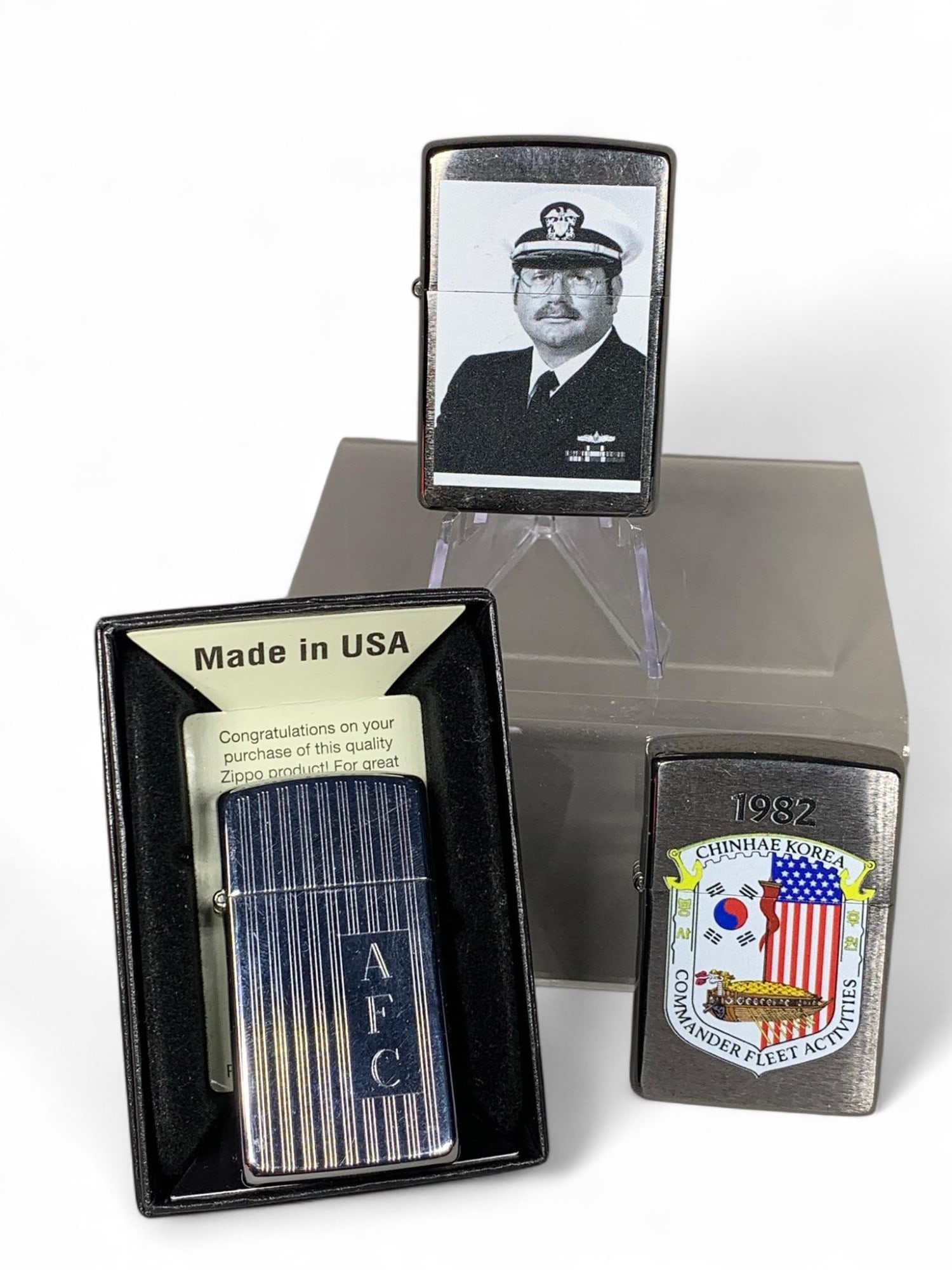 Three Zippo Lighters Including Military: Burns in-house shipping is available. pick up is Tuesday, July 28, from Noon to 7 pm at our gallery in Lancaster, Ohio 43130 or we will provide in-house shipping for this item. We will charge a $5 fee