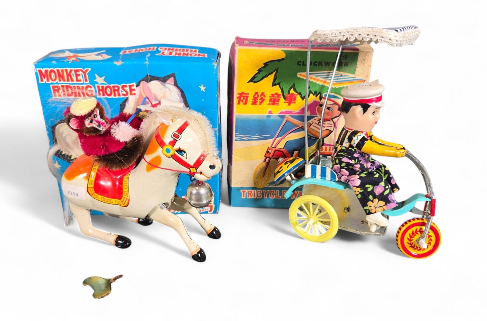 Vintage Wind-Up Tin Lithograph Toys: Monkey Riding a Horse and Tricycle with Bell: With original boxes. Untested. Burns in-house shipping is available. pick up is Tuesday, July 28, from Noon to 7 pm at our gallery in Lancaster, Ohio 43130 or we will provide in-house shipping for thi