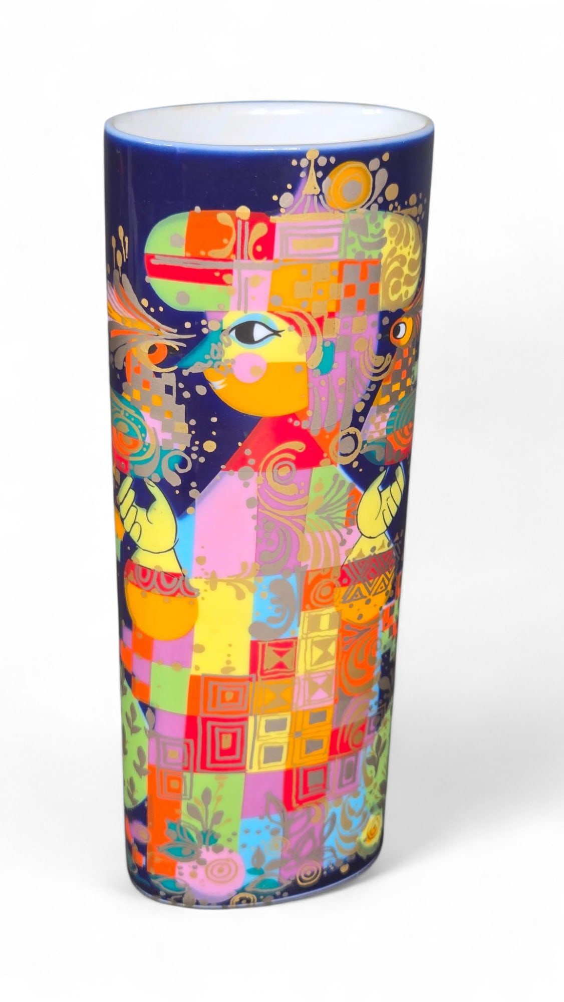 Bjorn Wiinblad Studio-Linie Cylindrical Vase - Abstract Multicolor Art, Blue Ceramic: This is a unique cylindrical vase, crafted from what appears to be ceramic or porcelain. The piece features a dark blue base adorned with vibrant, abstract multicolor artwork. The design incorporates