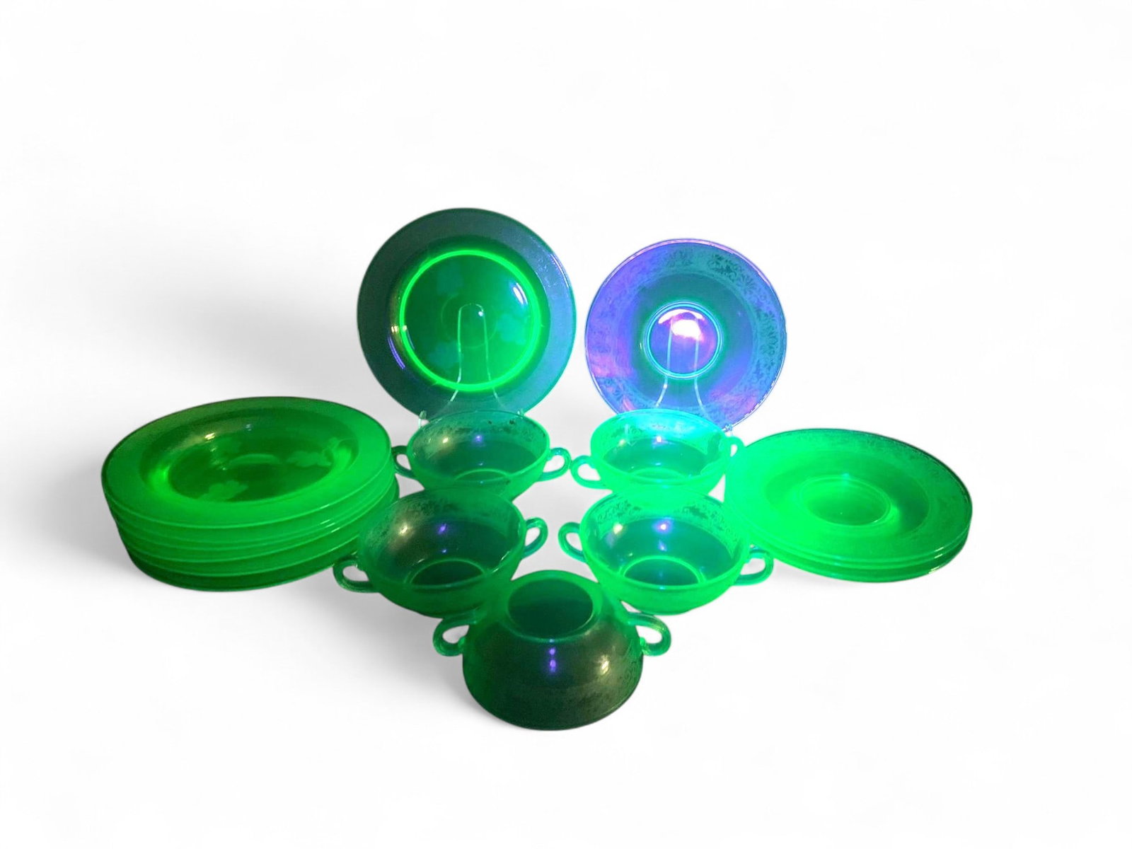 Vintage Uranium Vaseline Glass Dinnerware Set - UV Reactive Glow, Assorted Plates and Bowls, Green: This is a collection of vintage uranium glass dinnerware, commonly known as Vaseline glass. The set includes various types of dishes such as dinner plates, dessert plates, and an assortment of bowls,