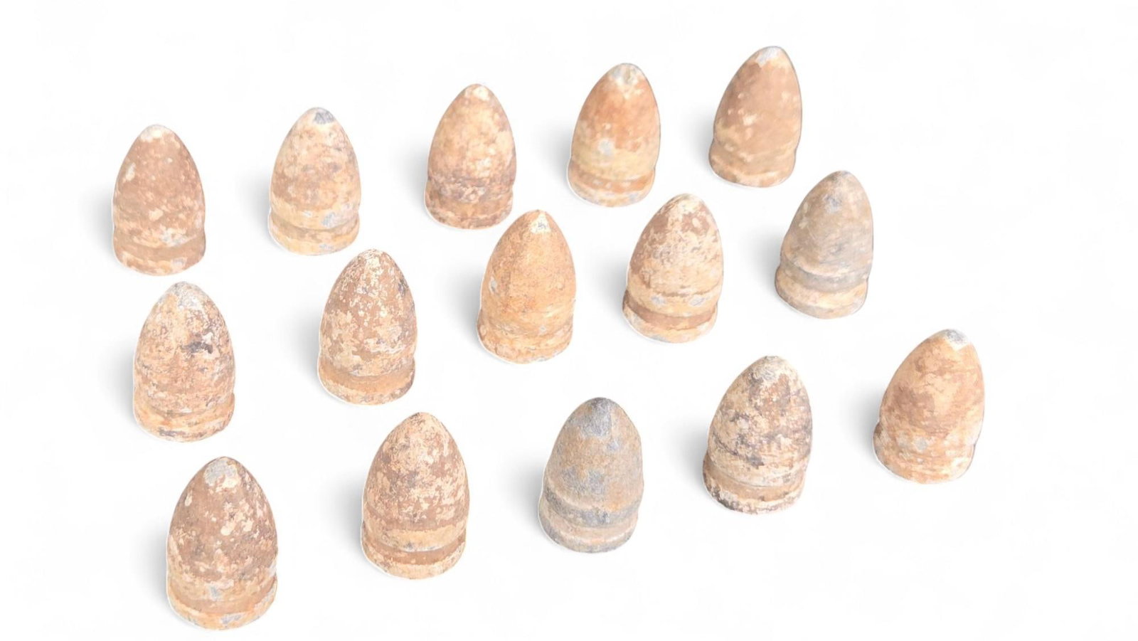 Antique Civil War Era Lead Minie Ball Projectiles - Group Lot, Oxidized Finish: This lot features historical lead projectiles, consistent with those used during the American Civil War era, commonly known as Minie balls. Each piece exhibits a distinctive conical shape with multipl