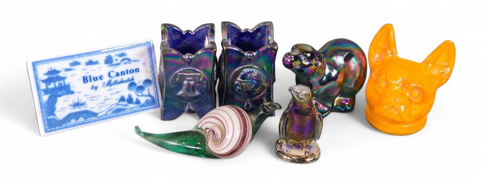 Art Glass Figurines Collection - Iridescent Animals, Blue Canton Tile, Vibrant Colors: This collection features various art glass items, including a ceramic tile depicting a scenic Blue Canton pattern, marked 'Blue Canton by Mottahedeh'. The lot also comprises a variety of glass figurin
