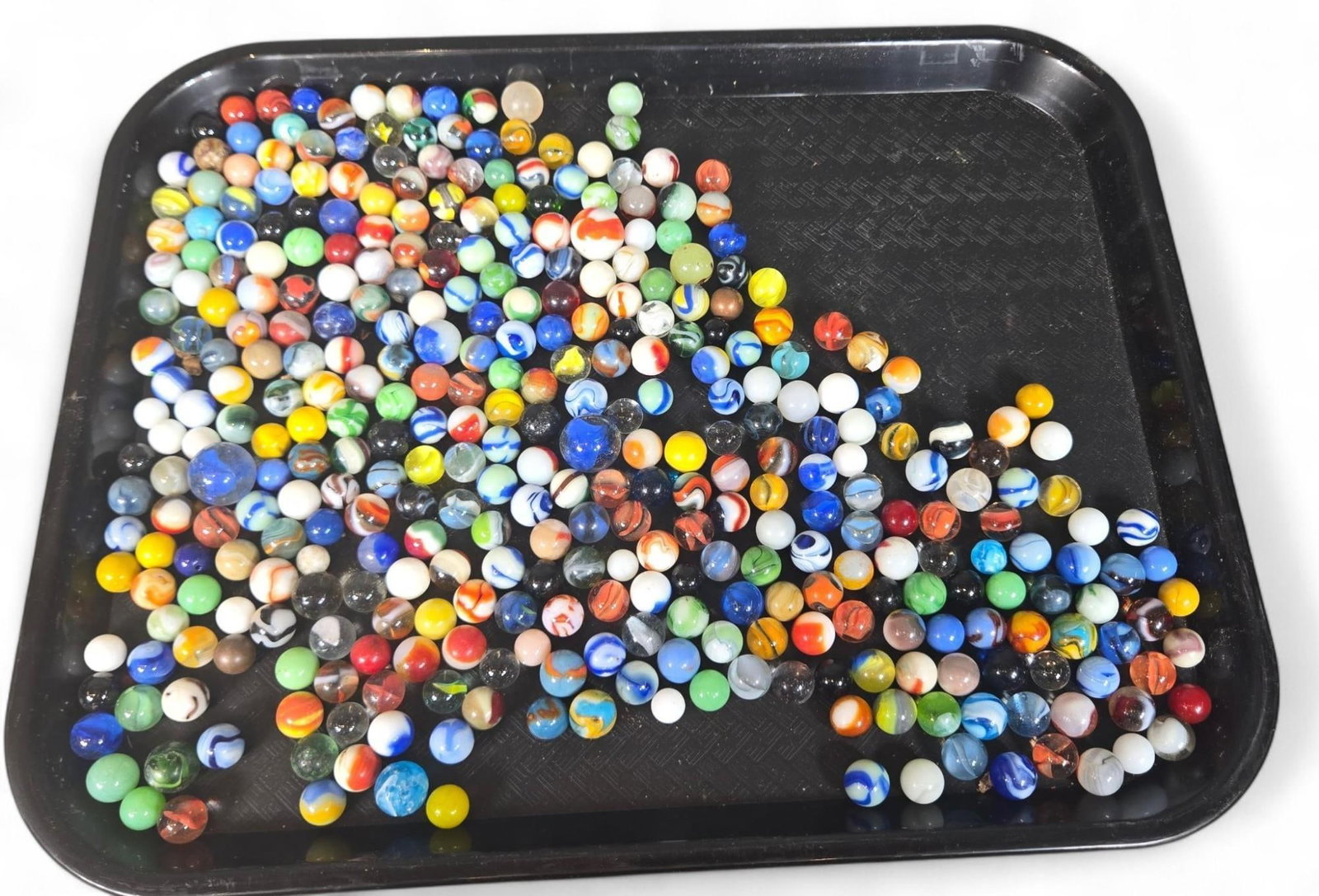 Marbles Collection - UV Reactive, Mixed Colors, Glows Under Blacklight: This lot features a diverse collection of glass marbles, showcasing a variety of vibrant colors, intricate patterns, and sizes. Many of the marbles in this assortment exhibit UV reactivity, glowing un