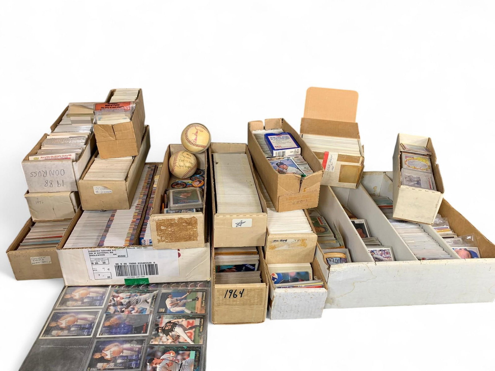 Donruss & Mixed Brand Sports Trading Card Collection - Vintage & Modern Baseball Cards, Includes Bas: This offering comprises a substantial collection of sports trading cards, predominantly baseball cards, presented in various storage boxes and protective sleeves. The lot includes items from different