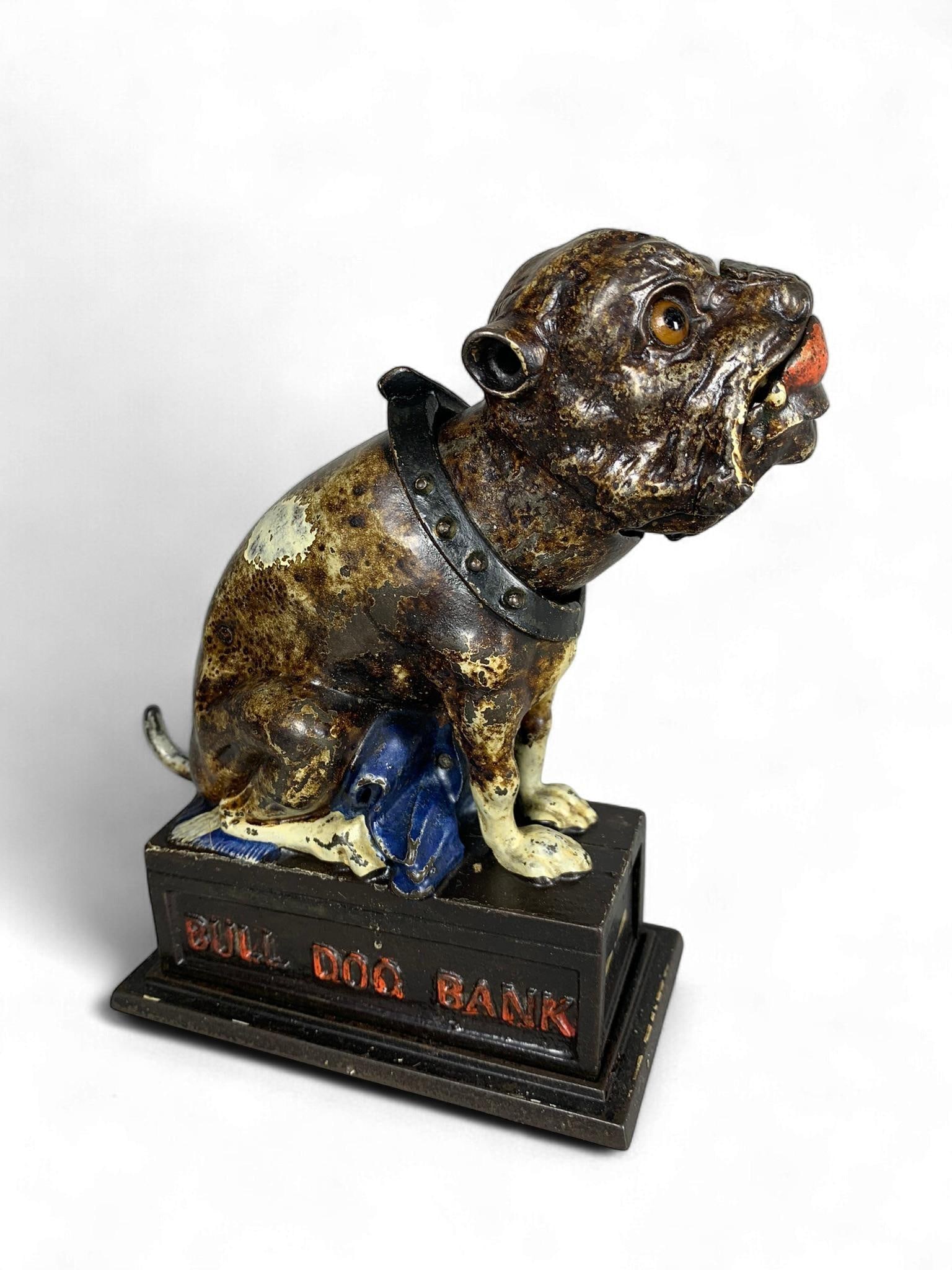 J. & E. Stevens 'Bull Dog' Cast Iron Mechanical Bank: A J. & E. Stevens 'Bull Dog' Cast Iron Mechanical Bank, American, late 19th century. This figural mechanical bank depicts a seated bulldog with a studded collar, rendered in painted cast iron and moun