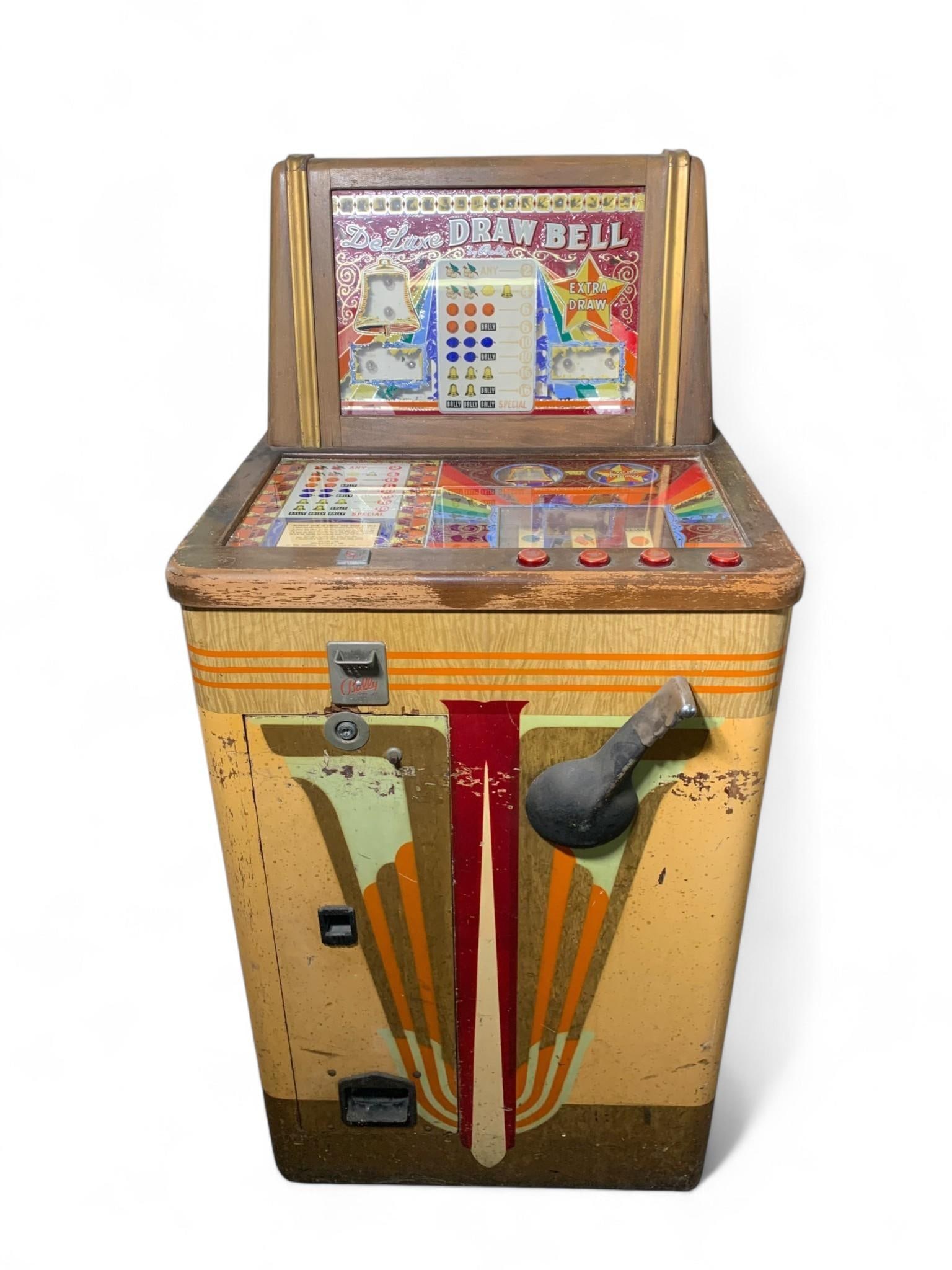 Vintage Bally 'DeLuxe Draw Bell' Electro-Mechanical Slot Machine, Model 7042: Works! See video. A vintage Bally 'DeLuxe Draw Bell' electro-mechanical slot or payout game, identified by markings including "Bally Mfg. Co. Chicago, Illinois, U.S.A." and model number "7042" on the