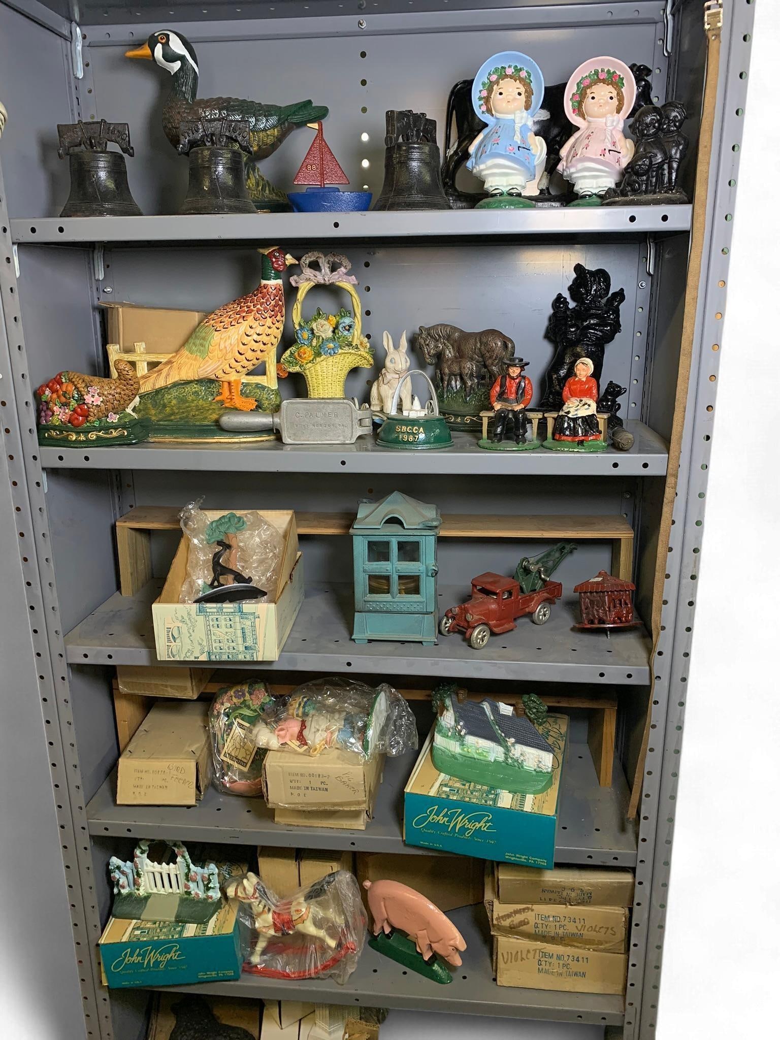 A Collection of Cast Iron Decorative Objects including an Arcade Toys 1920s Model A Tow Truck and Jo: A diverse collection of cast iron decorative objects, primarily featuring a vintage Arcade Toys 1920s Model A Tow Truck Wrecker with original red paint and green crane. The collection further includes