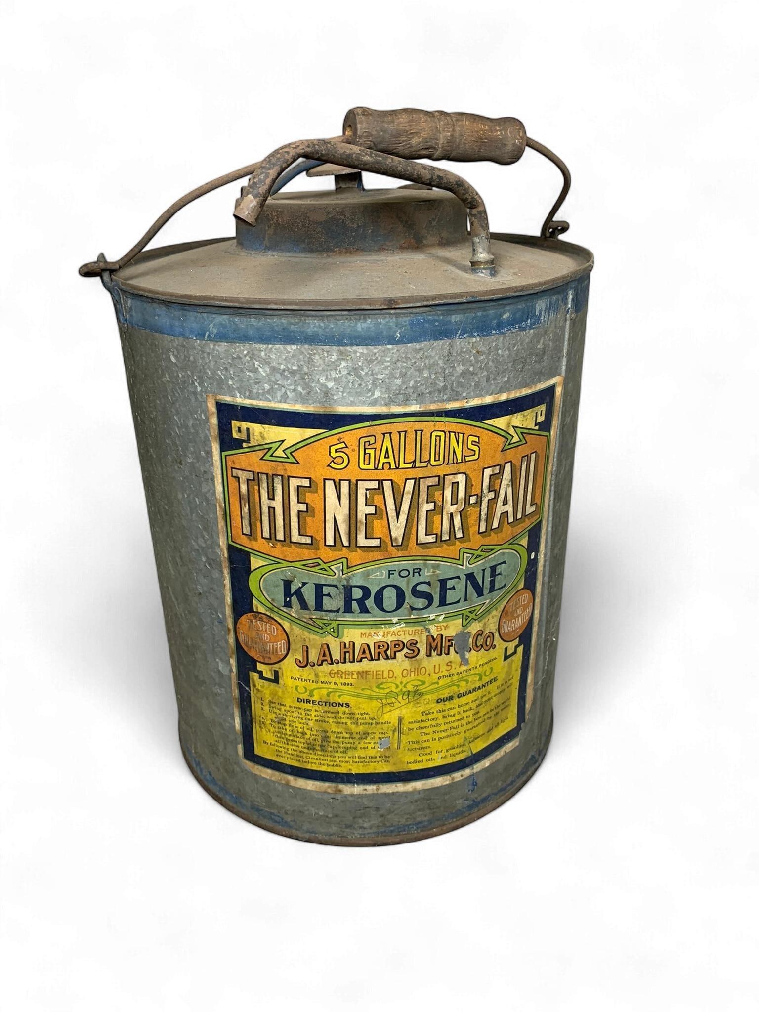 A J.A. Harps Mfg. Co. 'The Never-Fail' 5 Gallon Kerosene Can, dated 1893: A vintage cylindrical galvanized metal kerosene dispenser, identified as a 'The Never-Fail' 5 Gallon Kerosene Can manufactured by J.A. Harps Mfg. Co. of Greenfield, Ohio, U.S.A., with a patent date of
