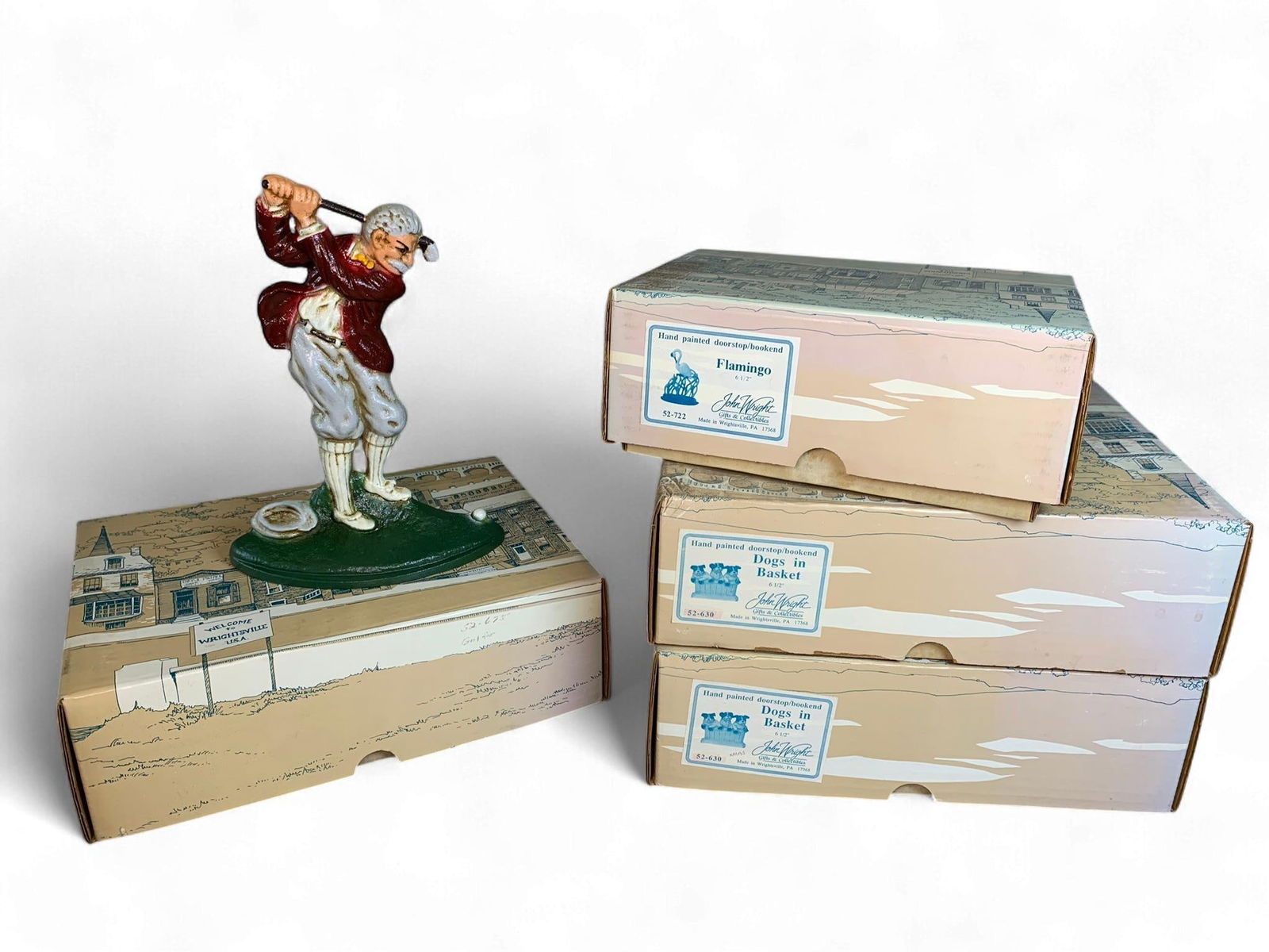 A Group of John Wright Cast Iron Figures and Doorstops: A Group of cast iron figures and doorstops by John Wright Gifts & Collectibles, Wrightsville, PA. The lot features a hand-painted cast iron figure of a male golfer in mid-swing, presented on a green b