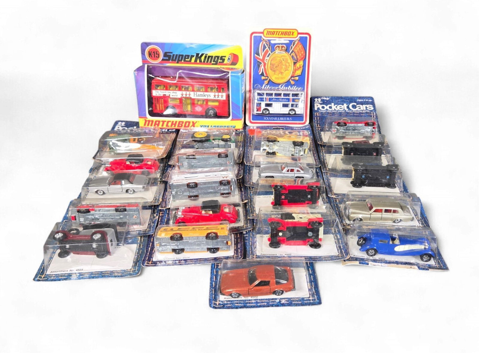 A Collection of Vintage Matchbox diecast Vehicles, Late 1970s-Early 1980s: This lot comprises a collection of vintage Matchbox diecast toy vehicles, primarily from their "Pocket Cars" series, complemented by a larger "SuperKings" Londoner bus and a "Silver Jubilee" London Ro