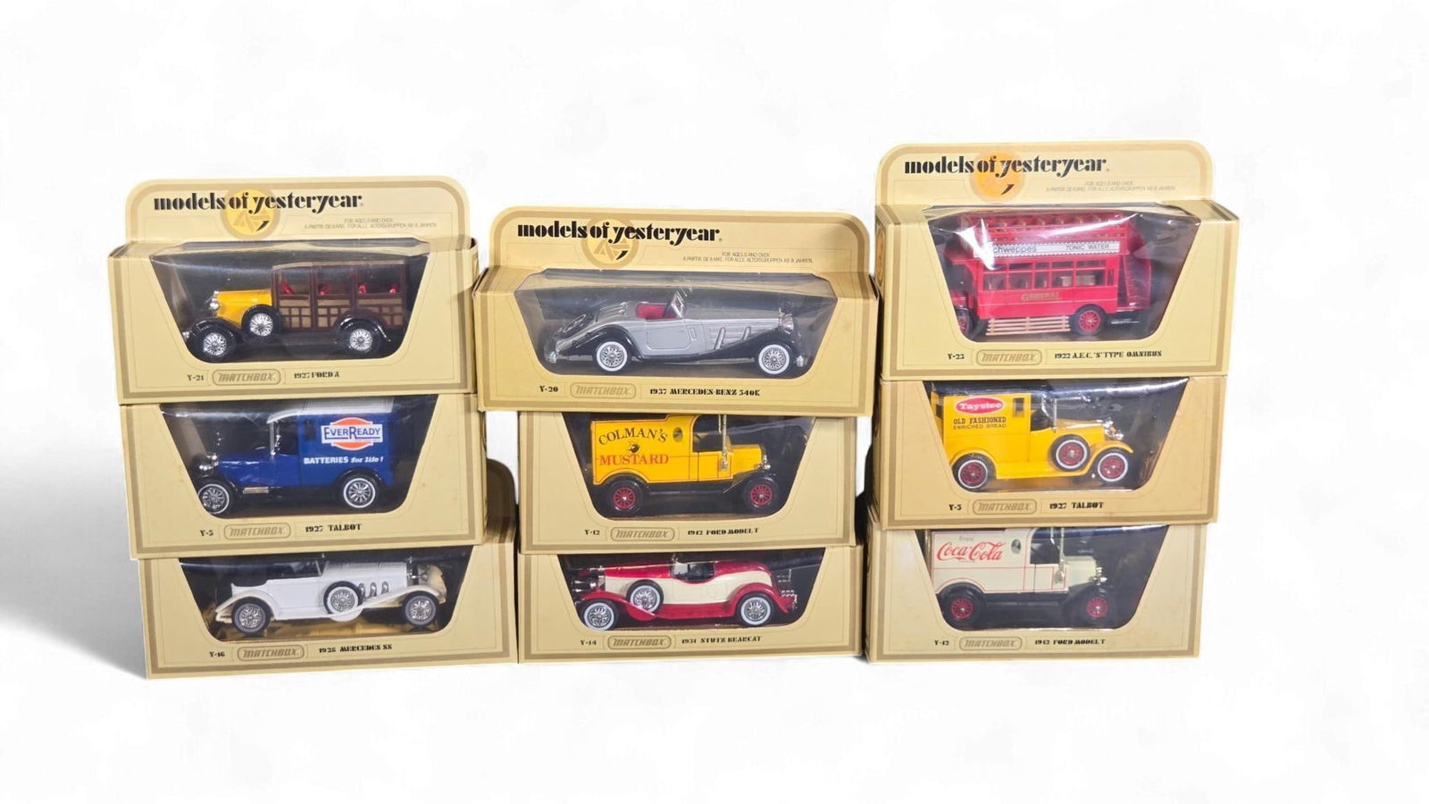 A Collection of Matchbox "Models of Yesteryear" diecast Toy Vehicles: A collection of Matchbox "Models of Yesteryear" diecast toy vehicles, largely preserved in their original cardboard and clear plastic display boxes. These miniature reproductions depict classic automo