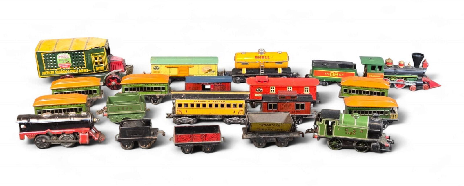 A Collection of Vintage Lithographed Tinplate Toy Trains and Truck by Marx, Lionel, Hornby, and Mar : A comprehensive collection of vintage lithographed tinplate toy trains and a single toy truck, primarily from the early to mid-20th century, featuring notable examples by Louis Marx and Co. (Joy Line)