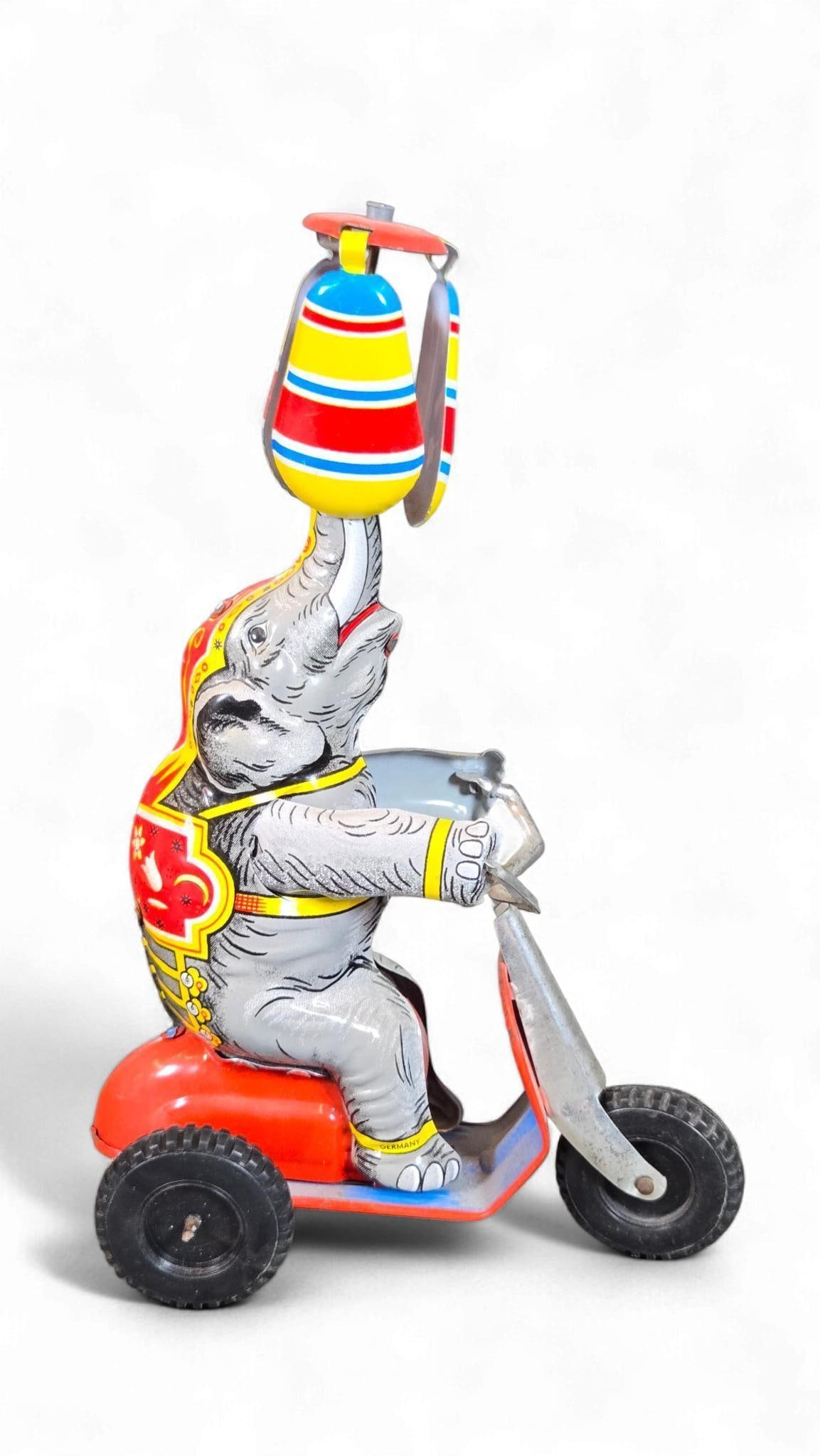 A JW Josef Wagner (U.S. Zone Germany) Tinplate Wind-Up Circus Elephant on Tricycle with Umbrella (1 of 8)